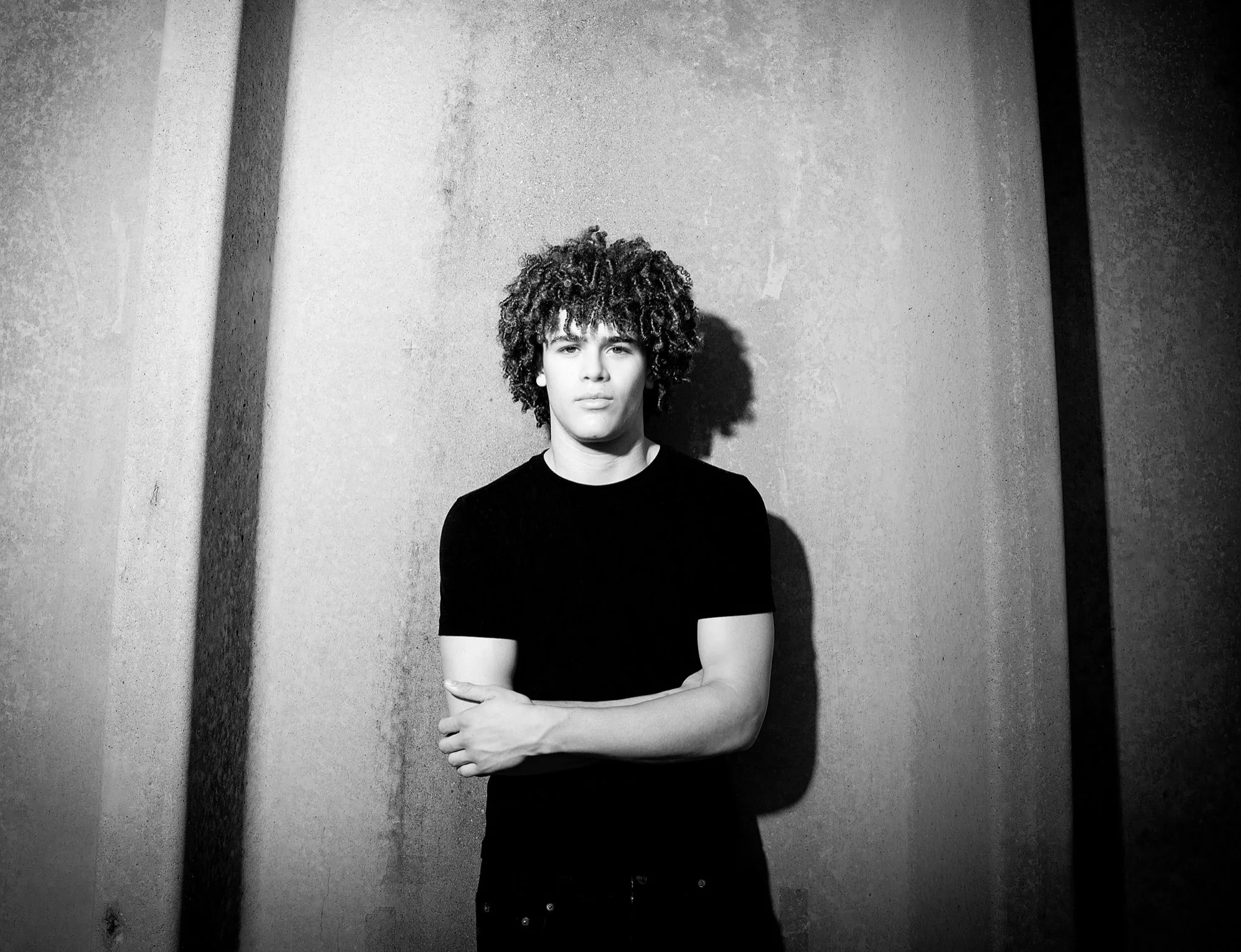 Drayden Lane, black-and-white portrait with arms crossed.