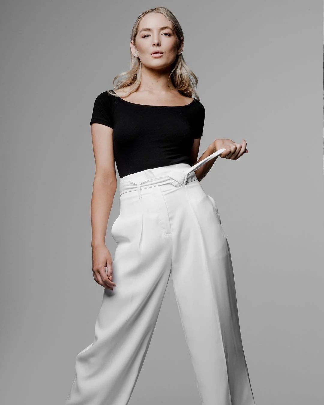 Maddie Jordan in white trousers and a black top, photographed by Tony Li.