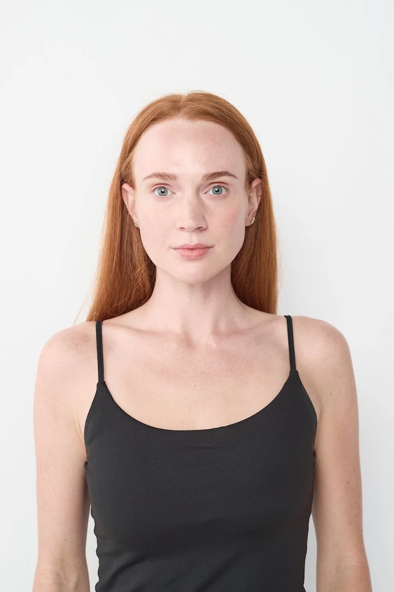 Taylor VanBebber, natural headshot with red hair against a white background.