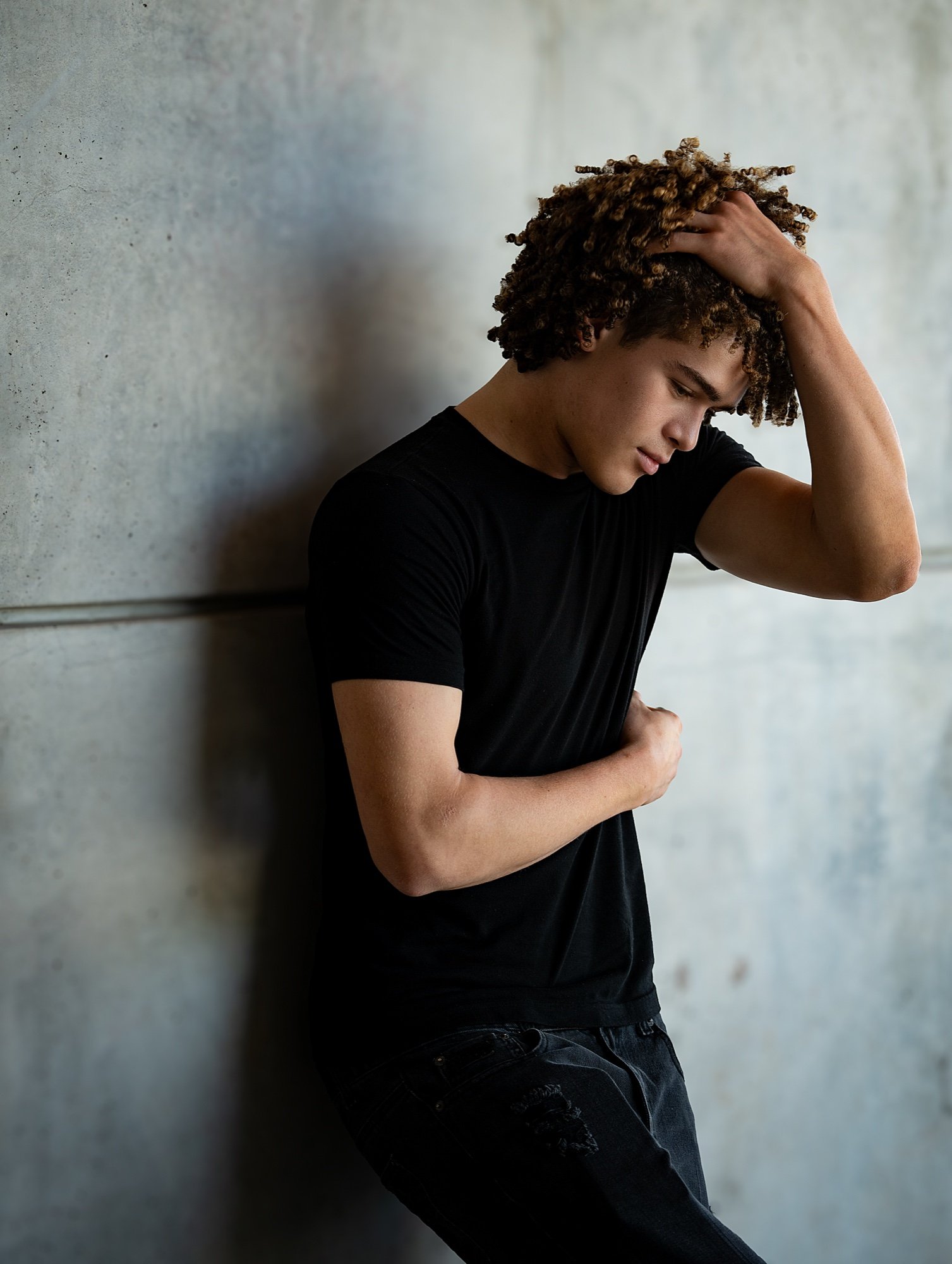 Drayden Lane, portrait with a hand in his hair.