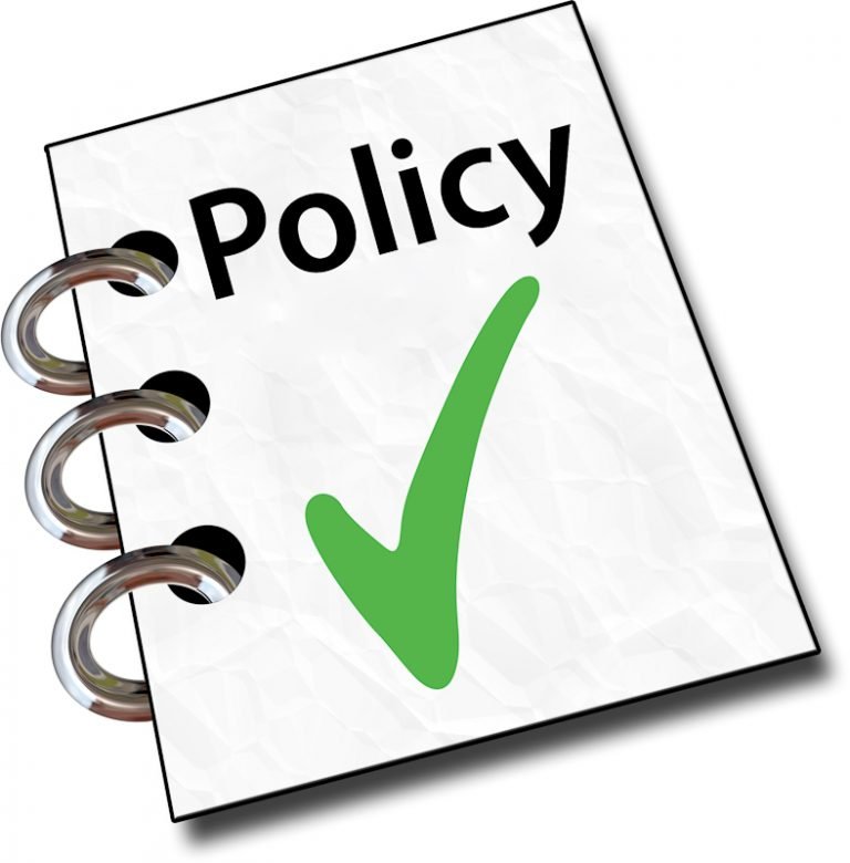 A policy document with three metal rings on the left side and a large green check mark on the cover