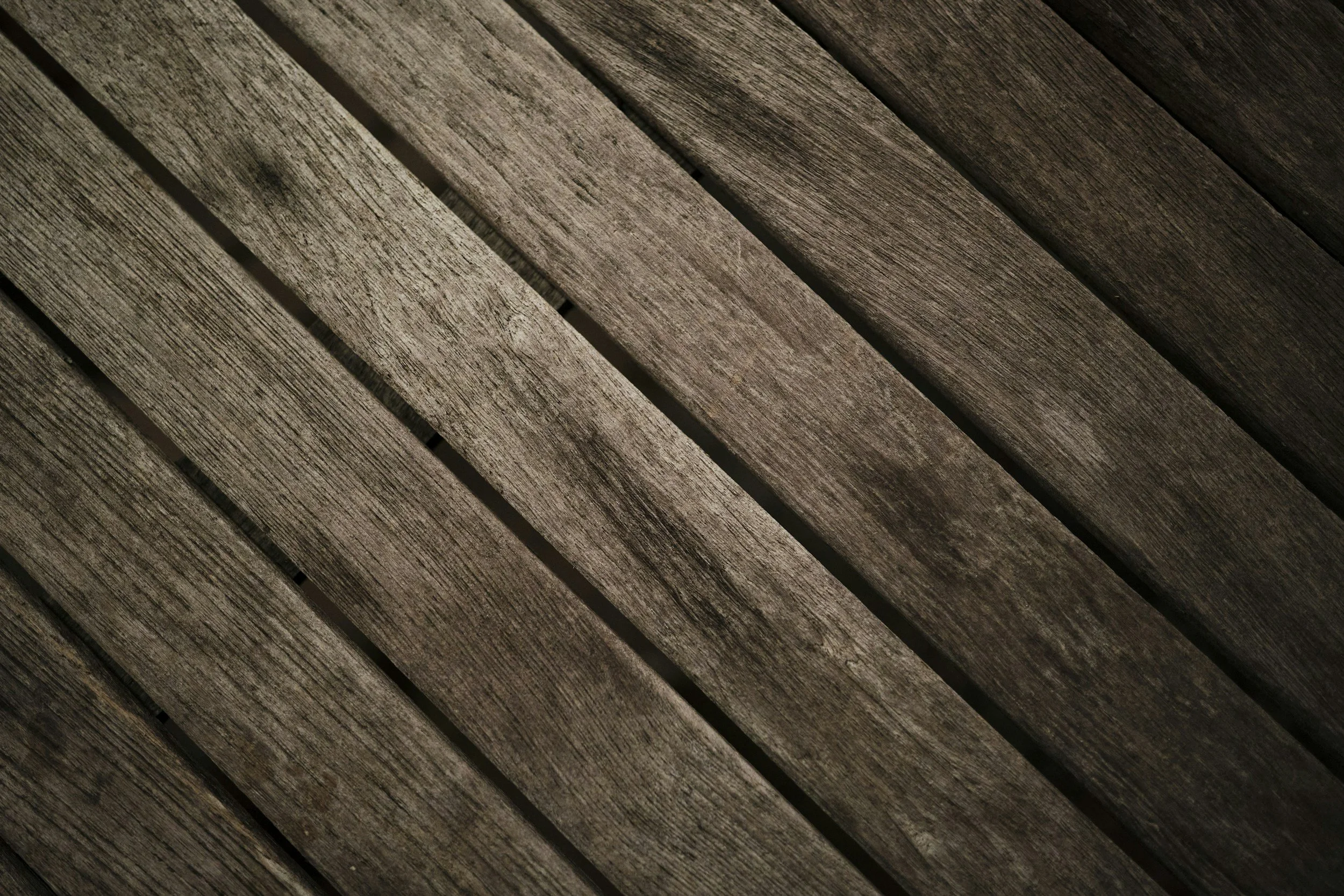 Close-up of weathered wooden planks arranged diagonally.