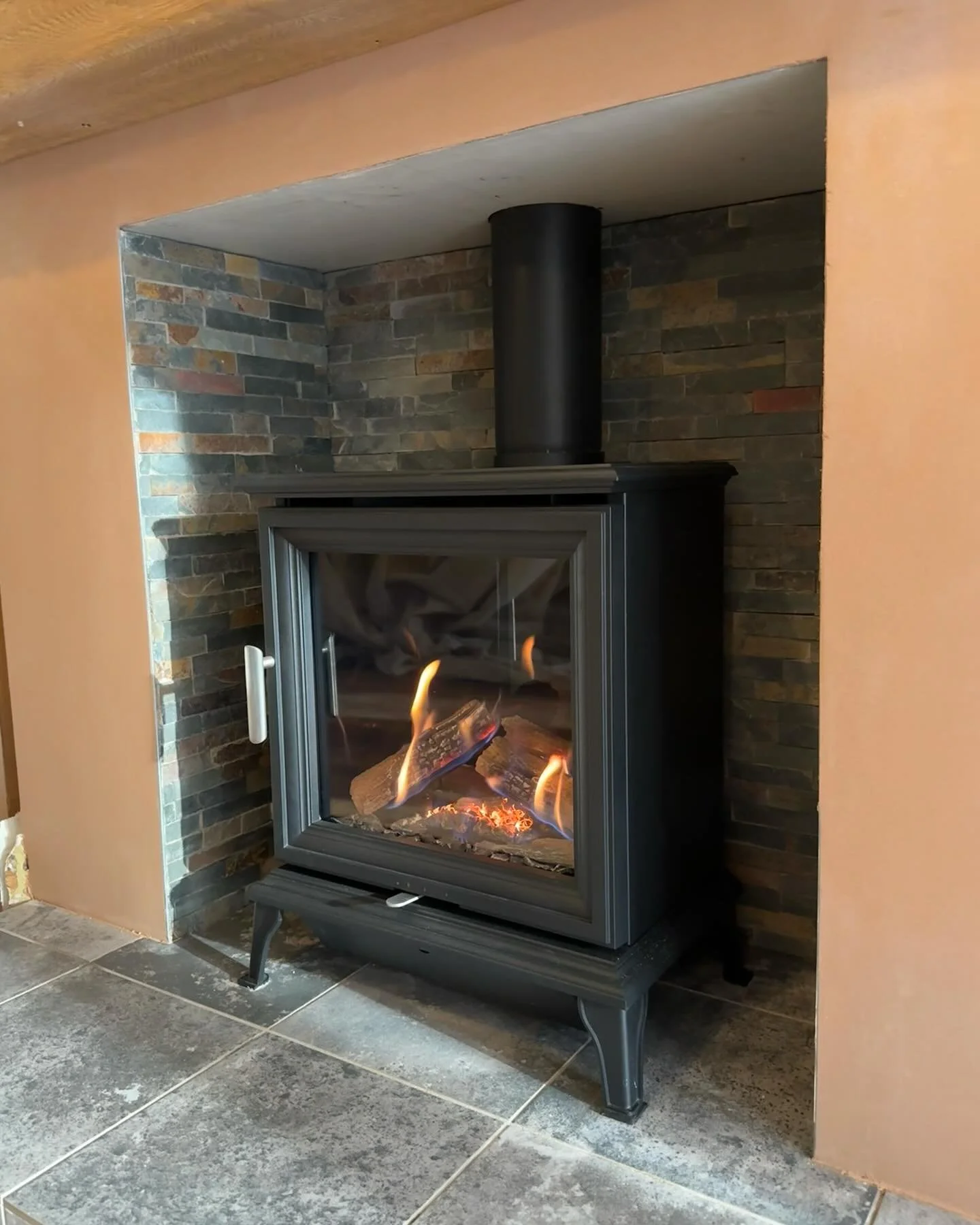 Recently completed installation of a Wildfire Ravel gas stove, complete with flue lining via cherry picker access. This project included a full knockout, new hearth installation, and a fully tiled chamber &mdash; delivering both function and a refine