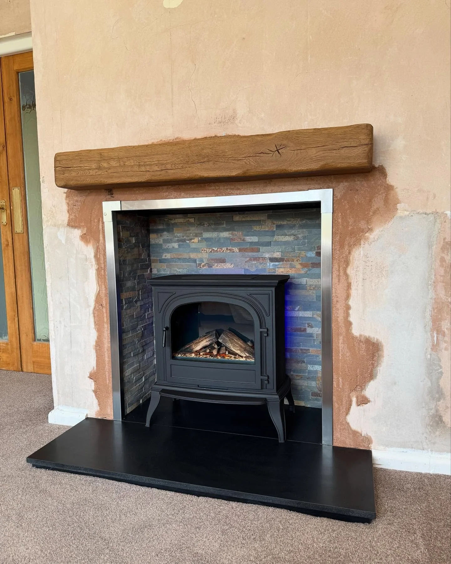 We swapped logs for LEDs 🔥 Instead of a wood burner, we&rsquo;ve gone electric with the British Fires Hinton stove. Knockout was a tough one (and a bit of a mess 😅), but now it&rsquo;s all in &mdash; granite hearth, tiled chamber, oak beam &mdash; 
