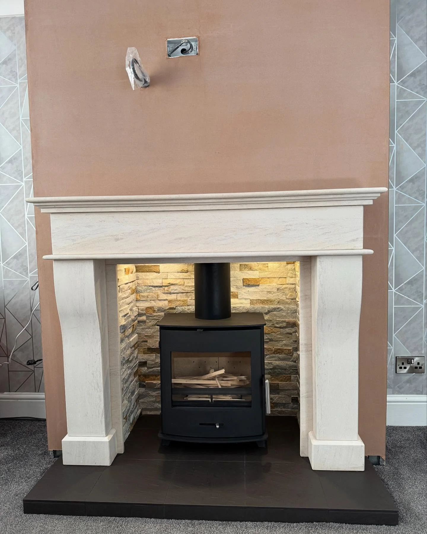 Bringing warmth and style together &mdash; a Pevex Newbourne 40FS with a sleek twin wall flue system, set within a timeless limestone fireplace and custom-built chimney breast. The heart of the home, redefined. 🔥 #FireplaceInspo #HomeStyle #Fireplac