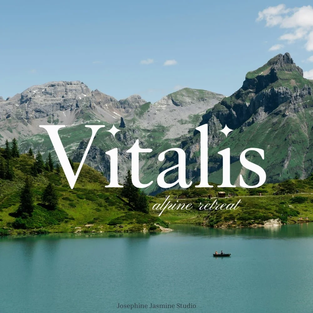 Scenic landscape of a mountain lake with green hills, rocky mountains in the background, and a small boat on the water, with text overlay reading 'Vítalis alpine retreat' and 'Josephine Jasmine Studio'.