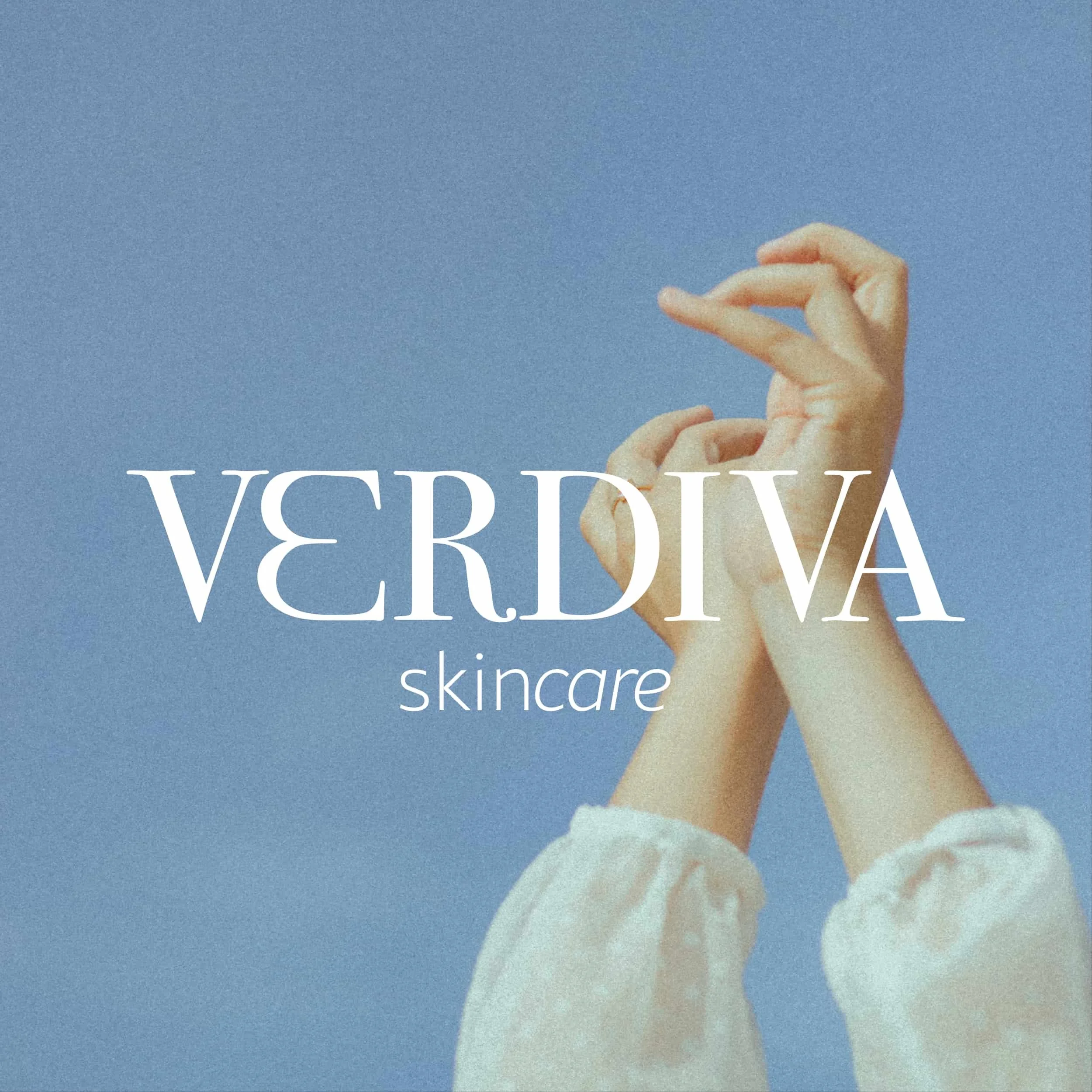 Hands  and white sleeves raised against a pale blue background, overlaid with the text 'VERDIVA skincare'.