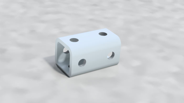 A metallic white coupler with multiple holes, used for connecting railroad cars, lying on a concrete surface.