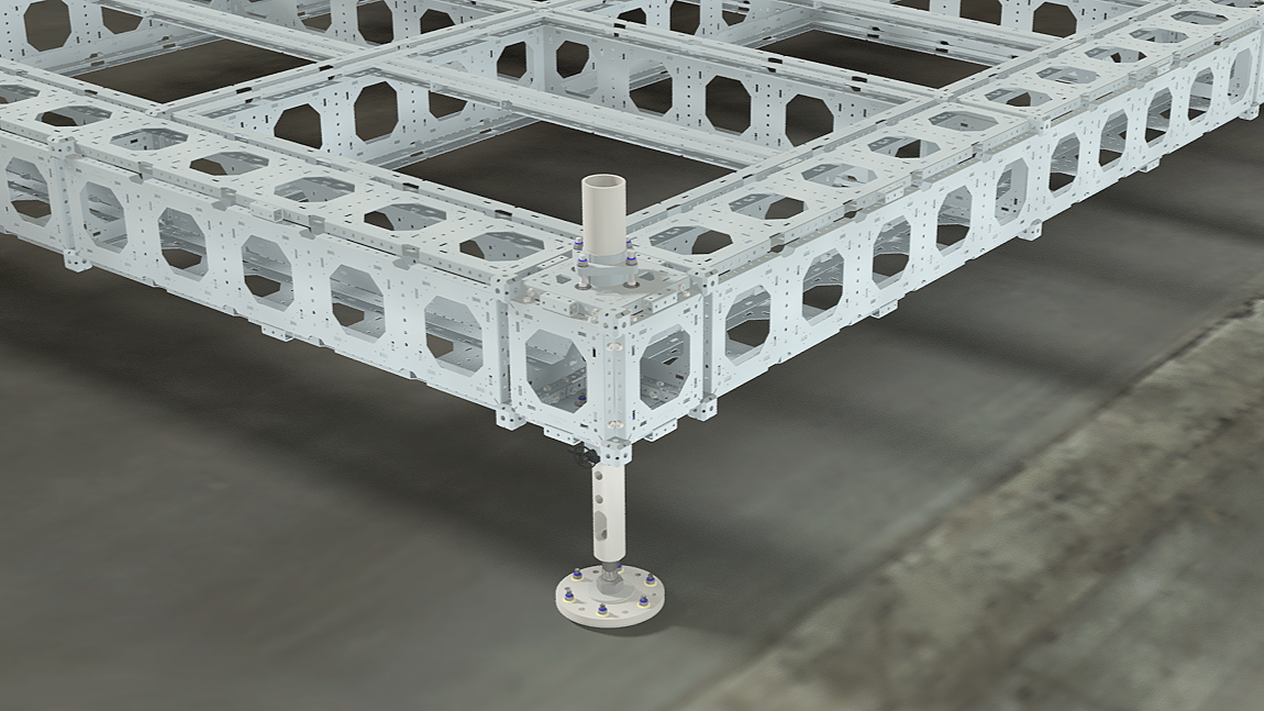 Close-up of a large metal structure or frame, possibly part of a robotics or engineering project, with a focus on one of the adjustable support legs.