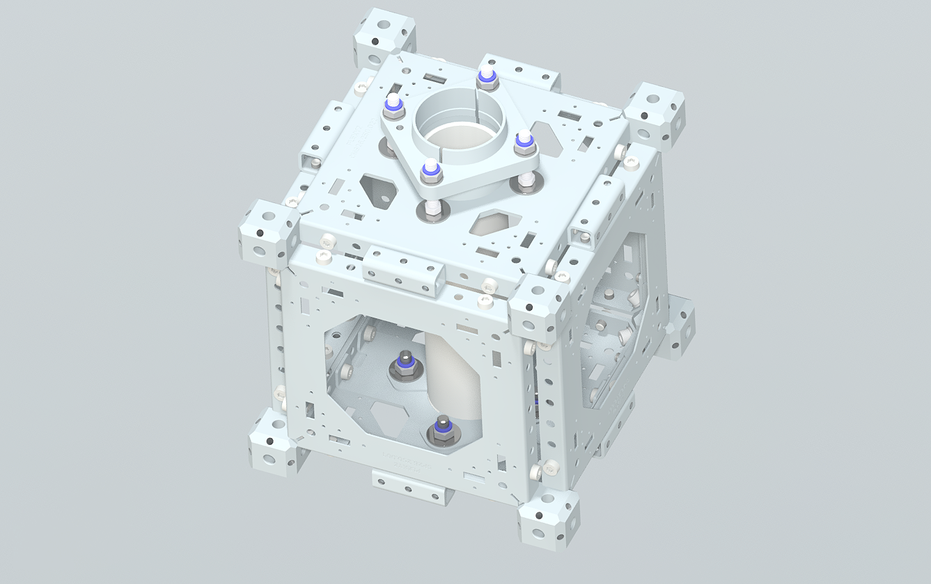 A metallic, cubic mechanical structure with various holes, screws, and components, resembling a precision engineering assembly or mechanical frame.
