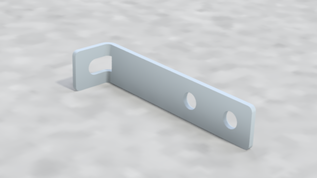A light gray metal L-shaped bracket with three holes, resting on a gray textured surface.
