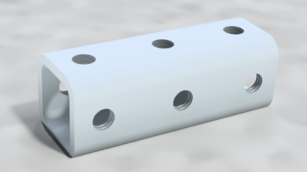 White metal rectangular block with rounded edges and six threaded holes