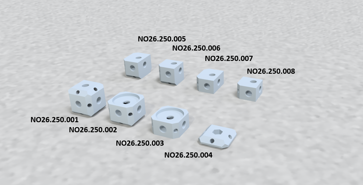 Several small white plastic or ceramic blocks with varying hole patterns, labeled with product numbers, on a light gray textured surface.