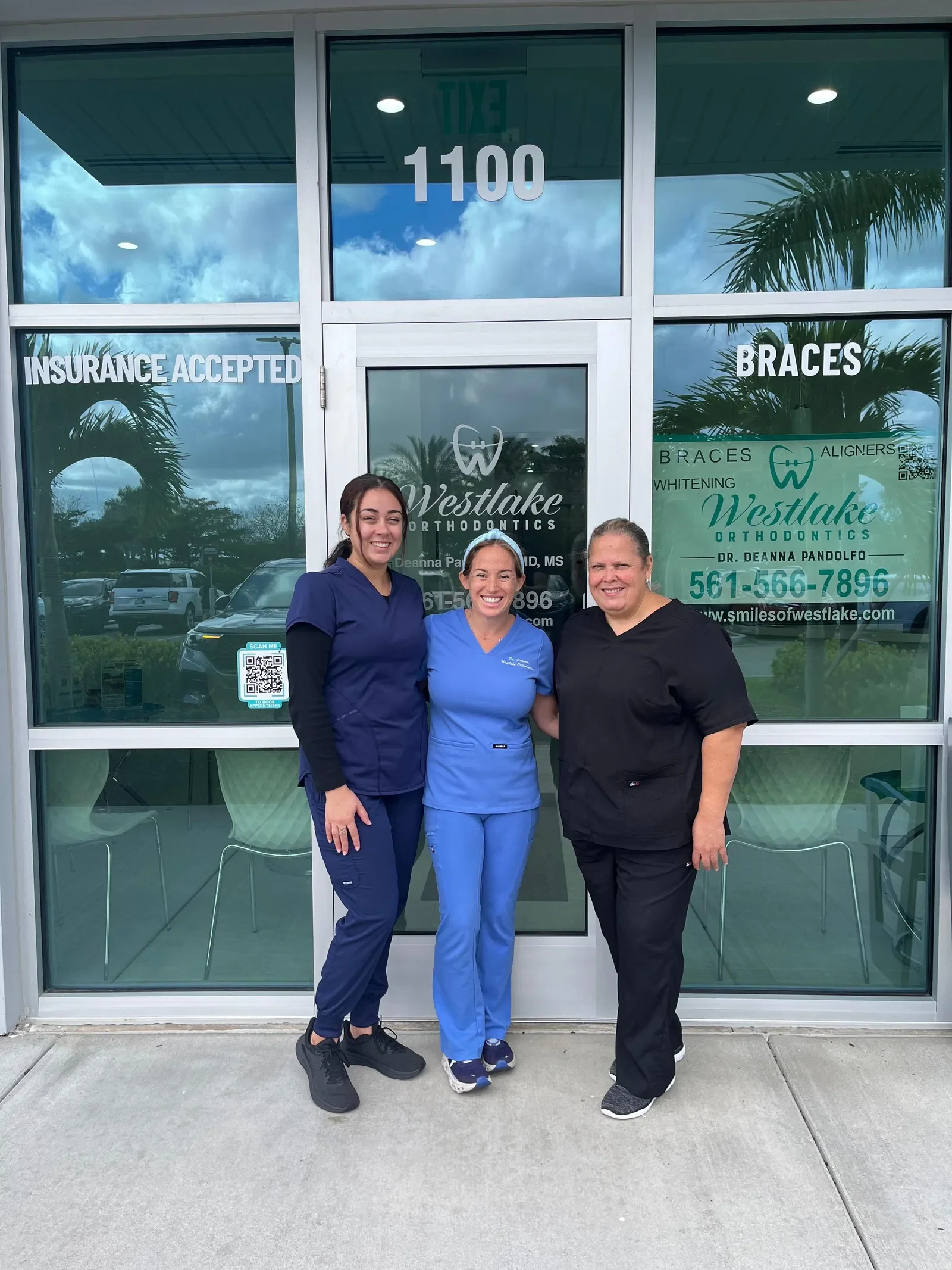Dr. Deanna Pandolfo with the Westlake Orthodontics team outside the Westlake, Florida office entrance.