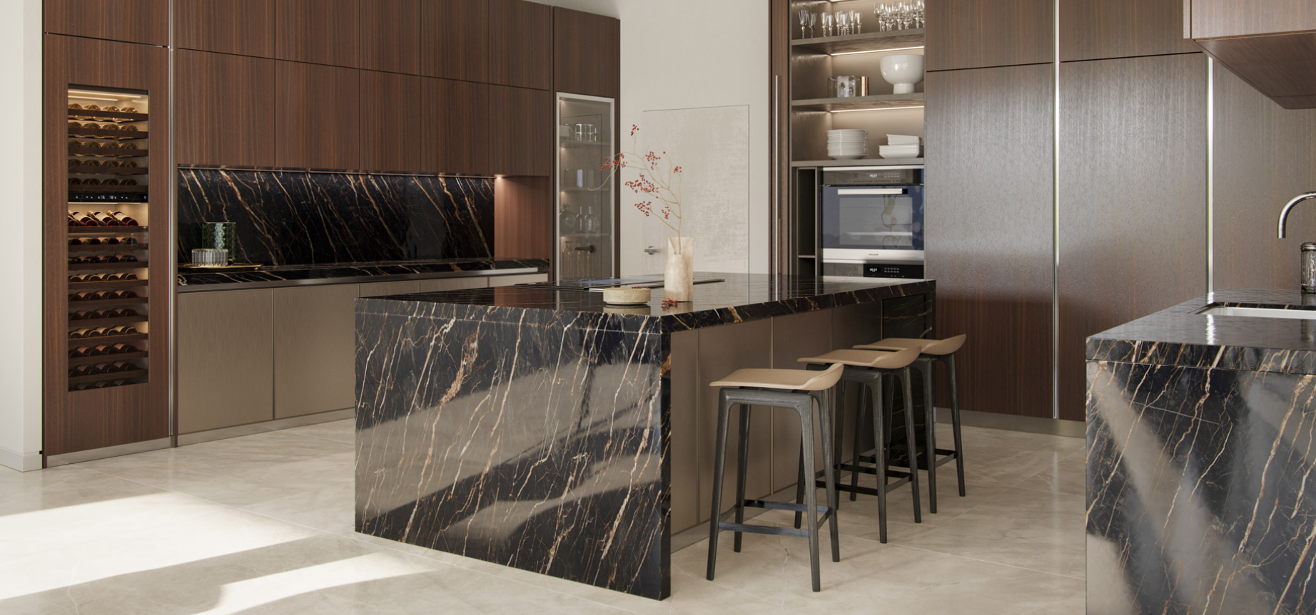 Modern kitchen with black marble countertops and island, stainless steel appliances, wooden cabinets, beige lower cabinets, wine fridge, bar stools, and decorative vase with branches.