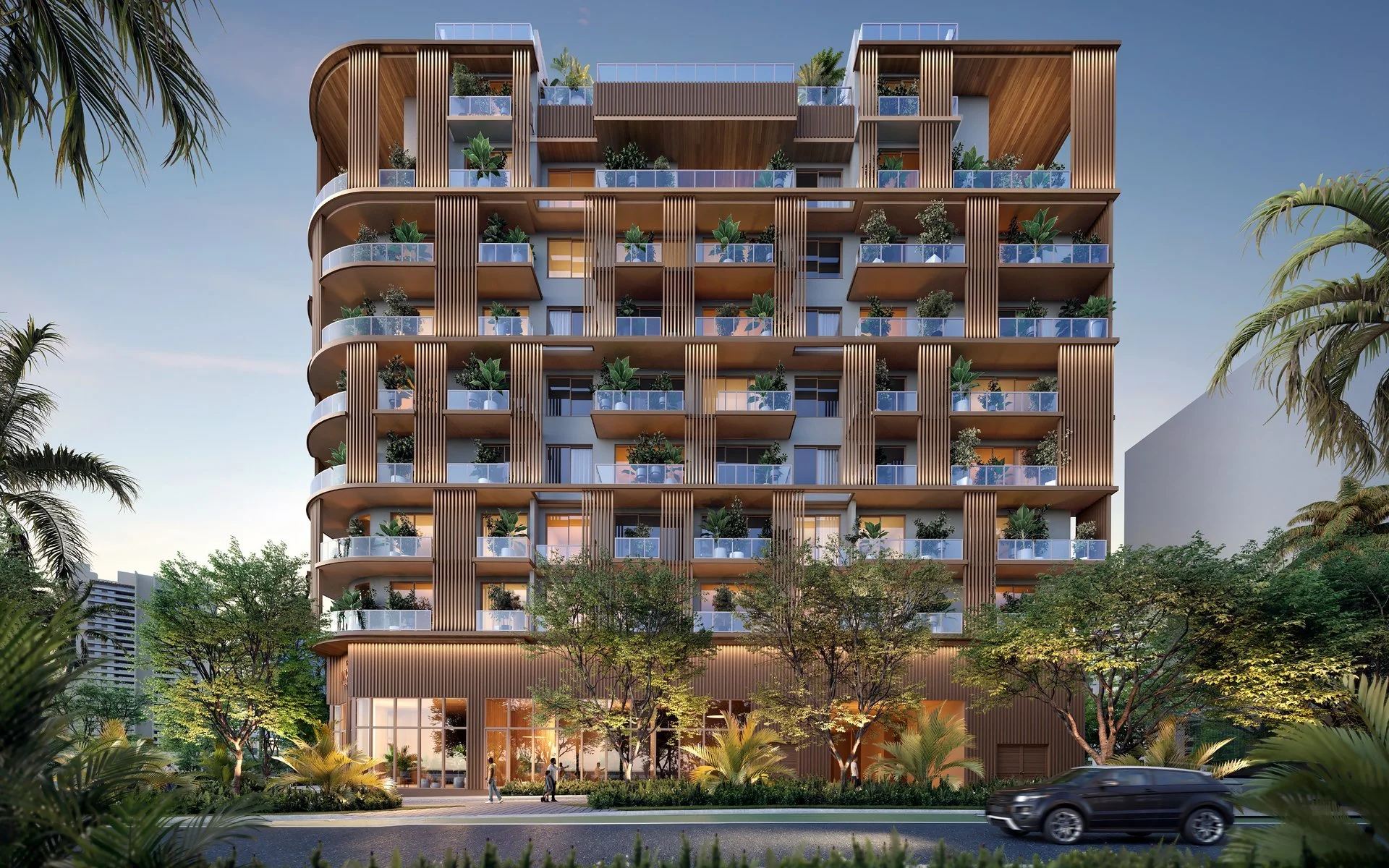 Modern multi-story apartment building with balconies glass railings and wooden slats, surrounded by trees and landscaping, with cars and pedestrians in the foreground.