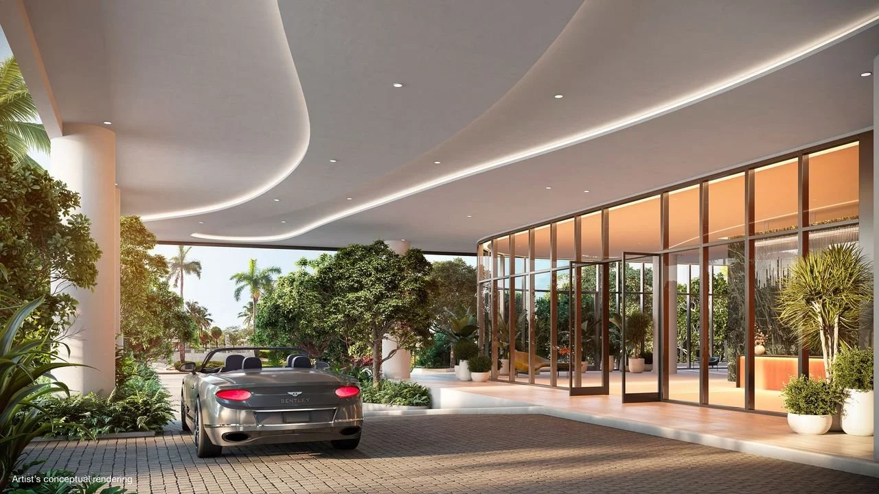 A modern luxury building with a car parked outside, surrounded by lush greenery, and large glass windows.