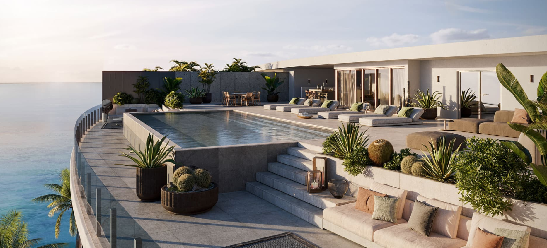 Luxury rooftop infinity pool with lounge chairs, potted plants, and ocean view