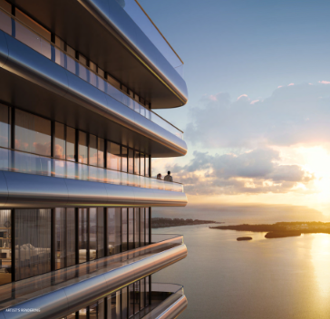 Modern multi-story building with glass balconies overlooking water at sunset.