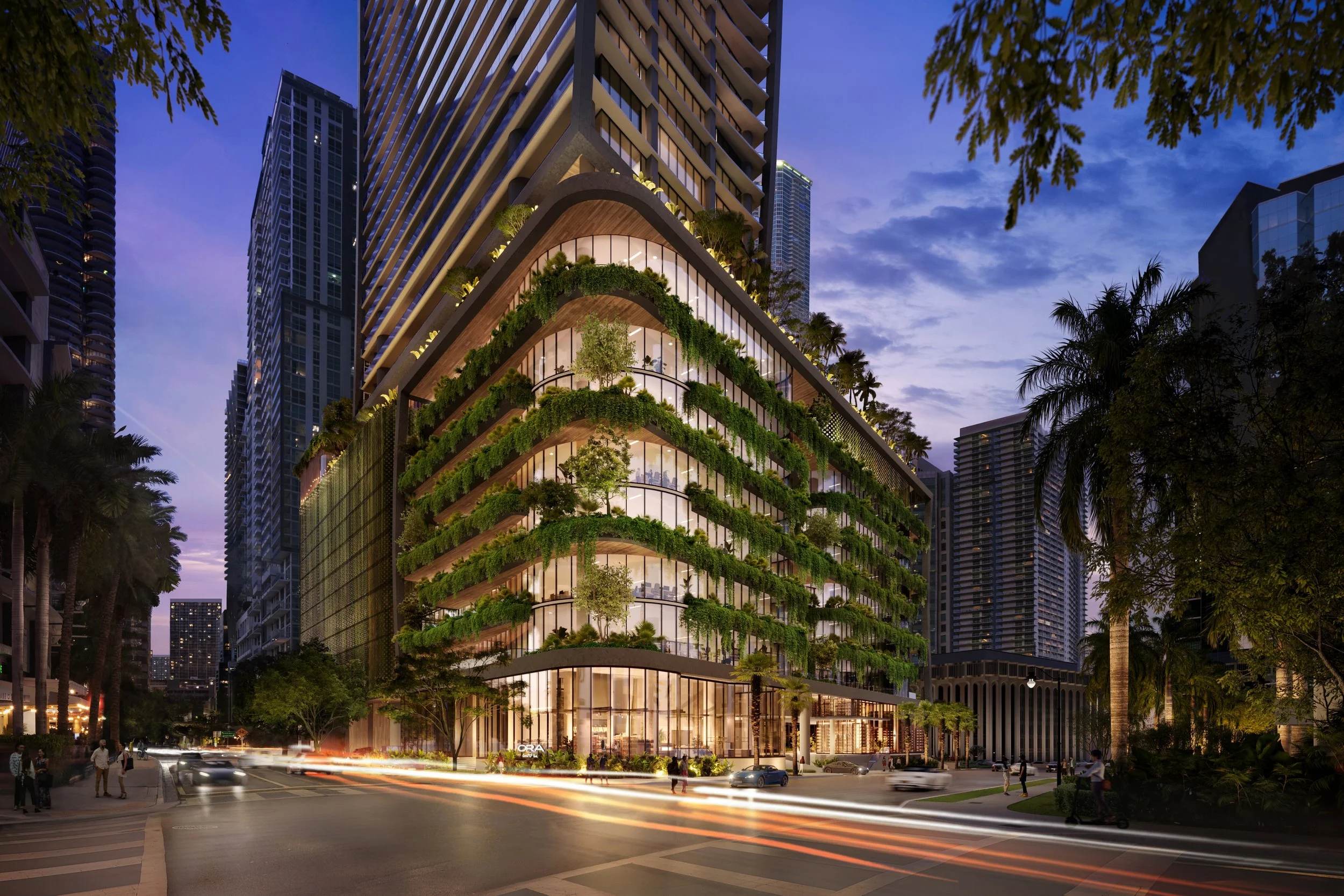 A modern high-rise building with extensive greenery on its balconies, set against a cityscape at dusk with purple and blue sky, surrounded by other tall buildings and palm trees, with traffic and pedestrians in the foreground.