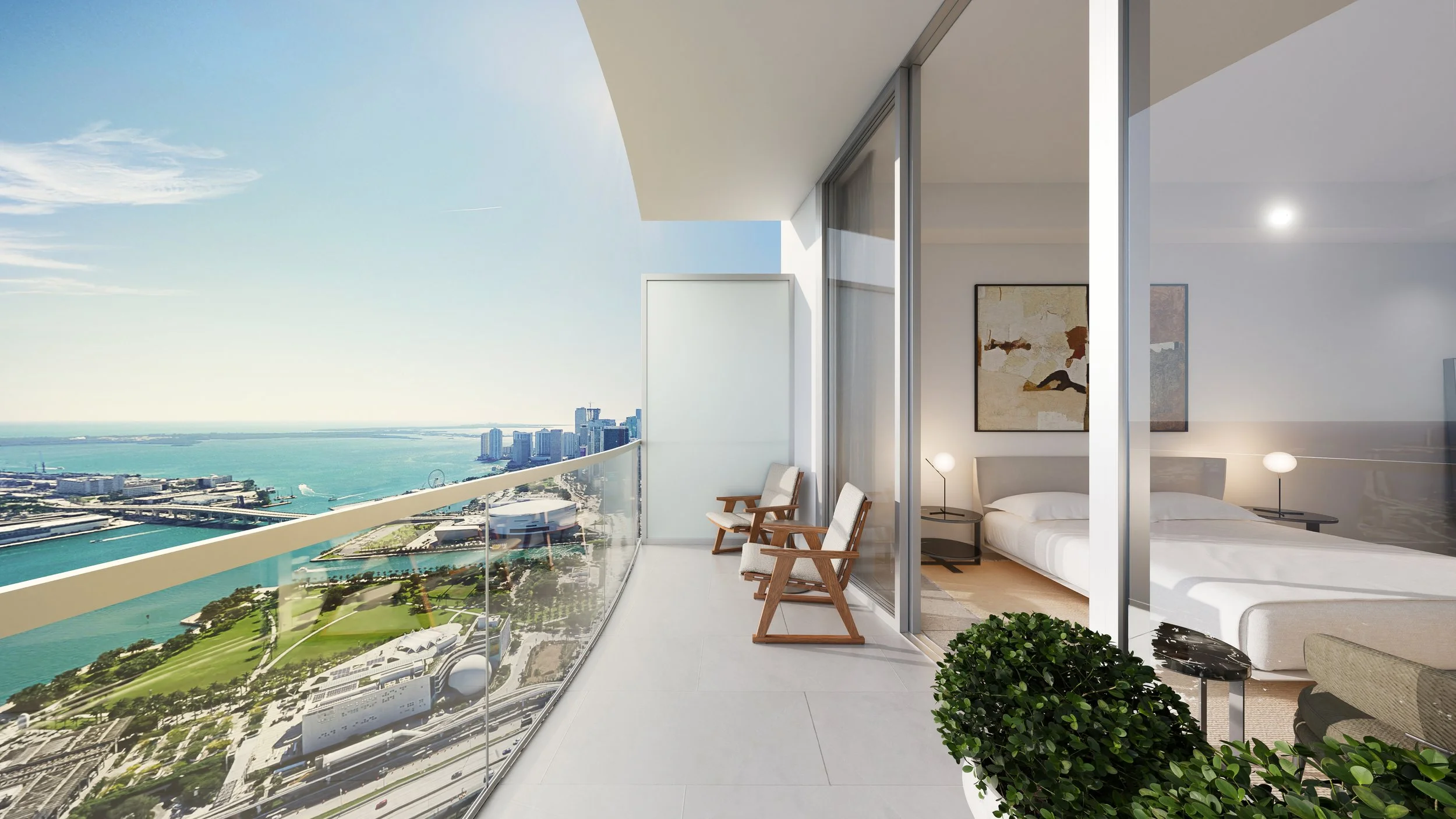 Modern high-rise balcony with city skyline view, two chairs, and a glass door leading to a bedroom with artwork and nightstands.