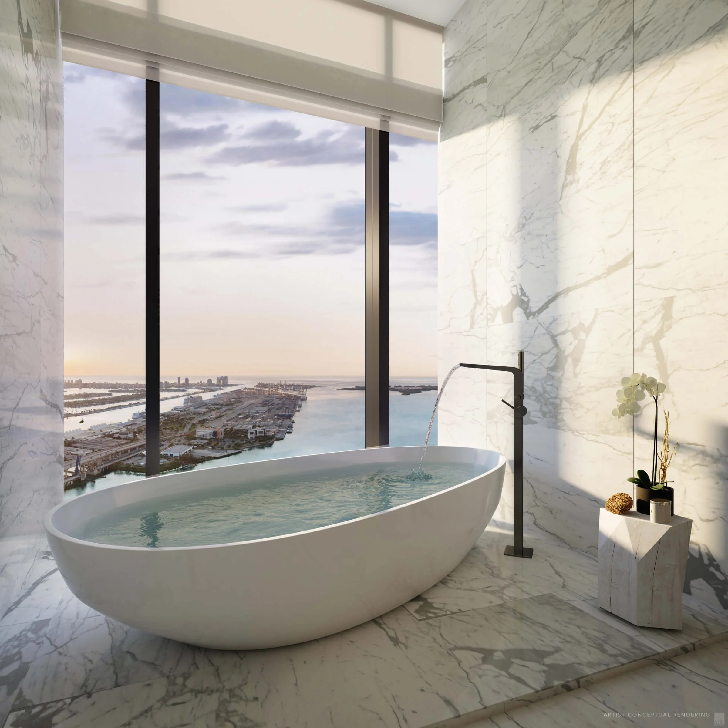 Modern bathroom with a white freestanding bathtub near large floor-to-ceiling windows showing a city view with water and buildings, decorated with a small plant and decorative items on a marble side table.