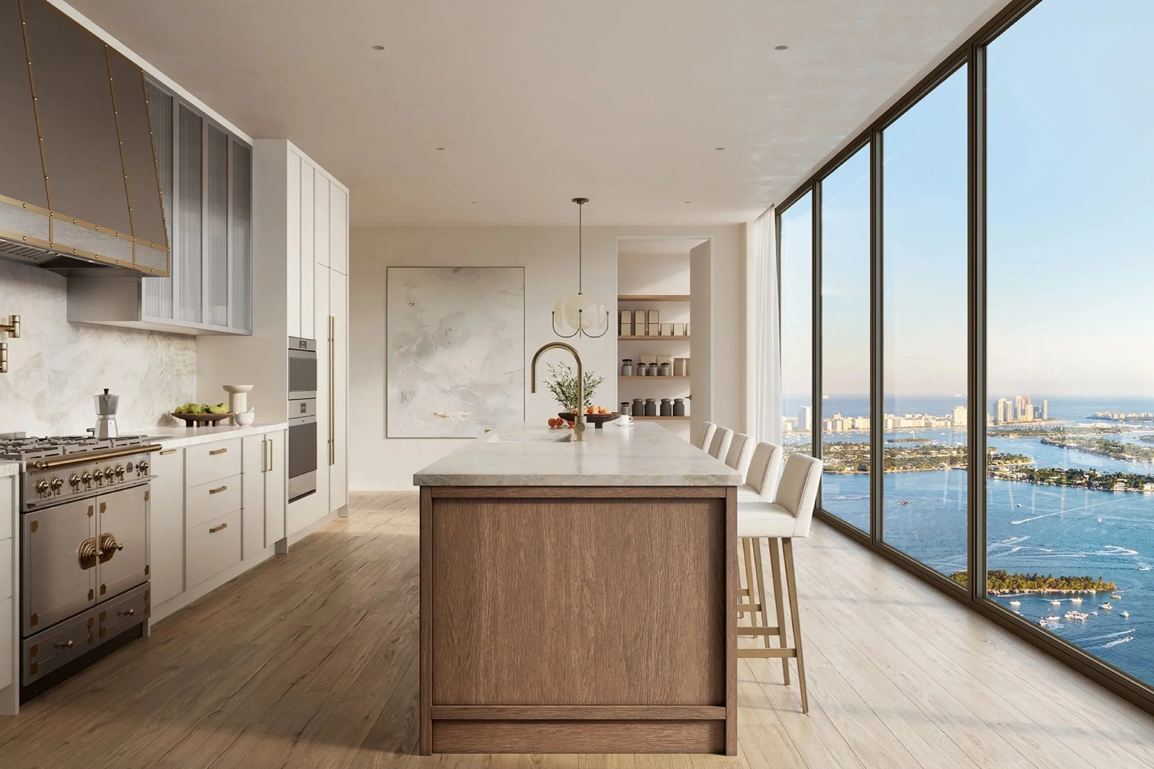 Modern kitchen with a large island, white cabinets, stainless steel appliances, and a view of a city skyline and water through floor-to-ceiling windows.