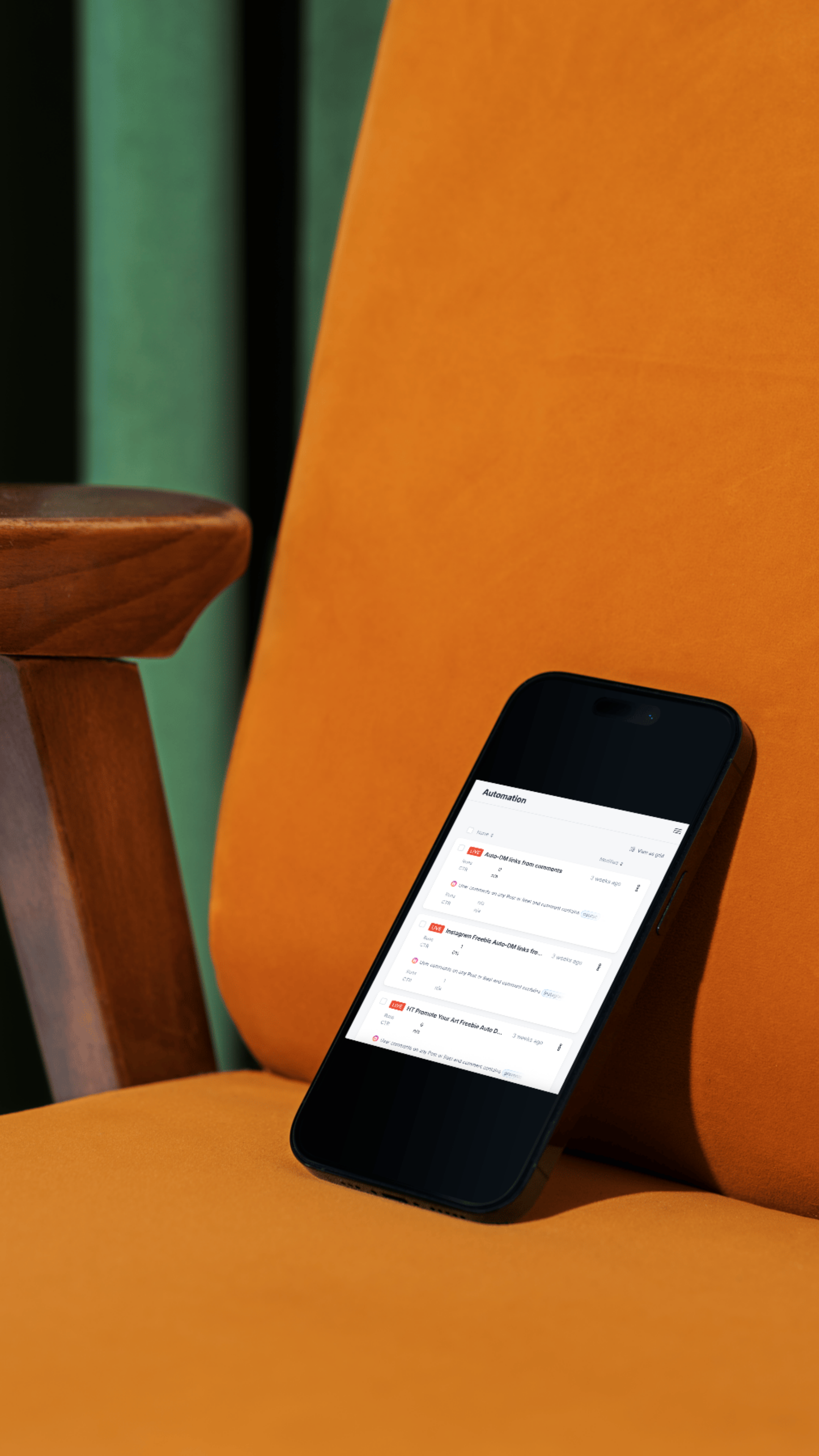 Smartphone with social media automation app on a yellow cushion next to a wooden armrest and a green wall.