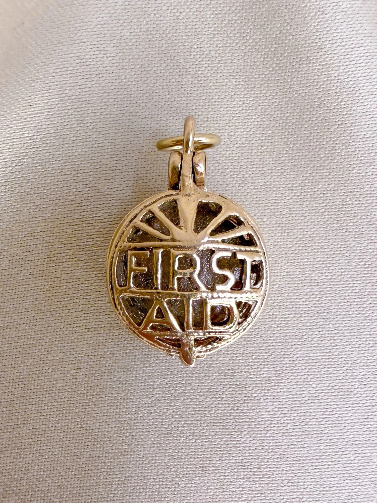 First Aid Charm. 9ct Gold.