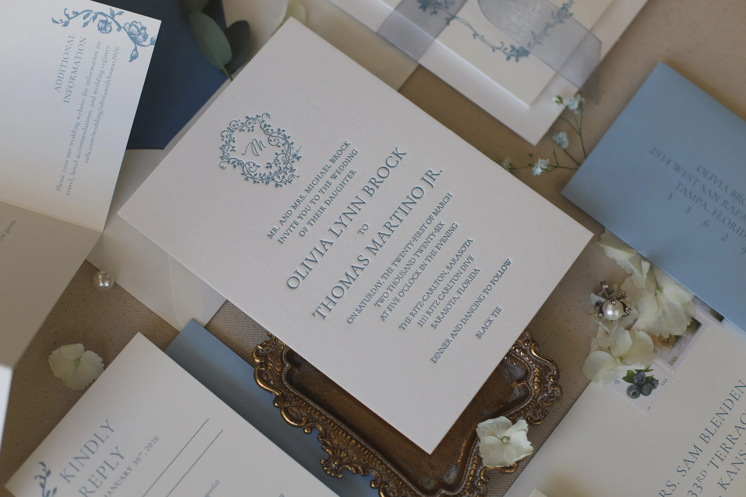 Blue floral Chinoiserie letterpress wedding invitations with floral monogram crest