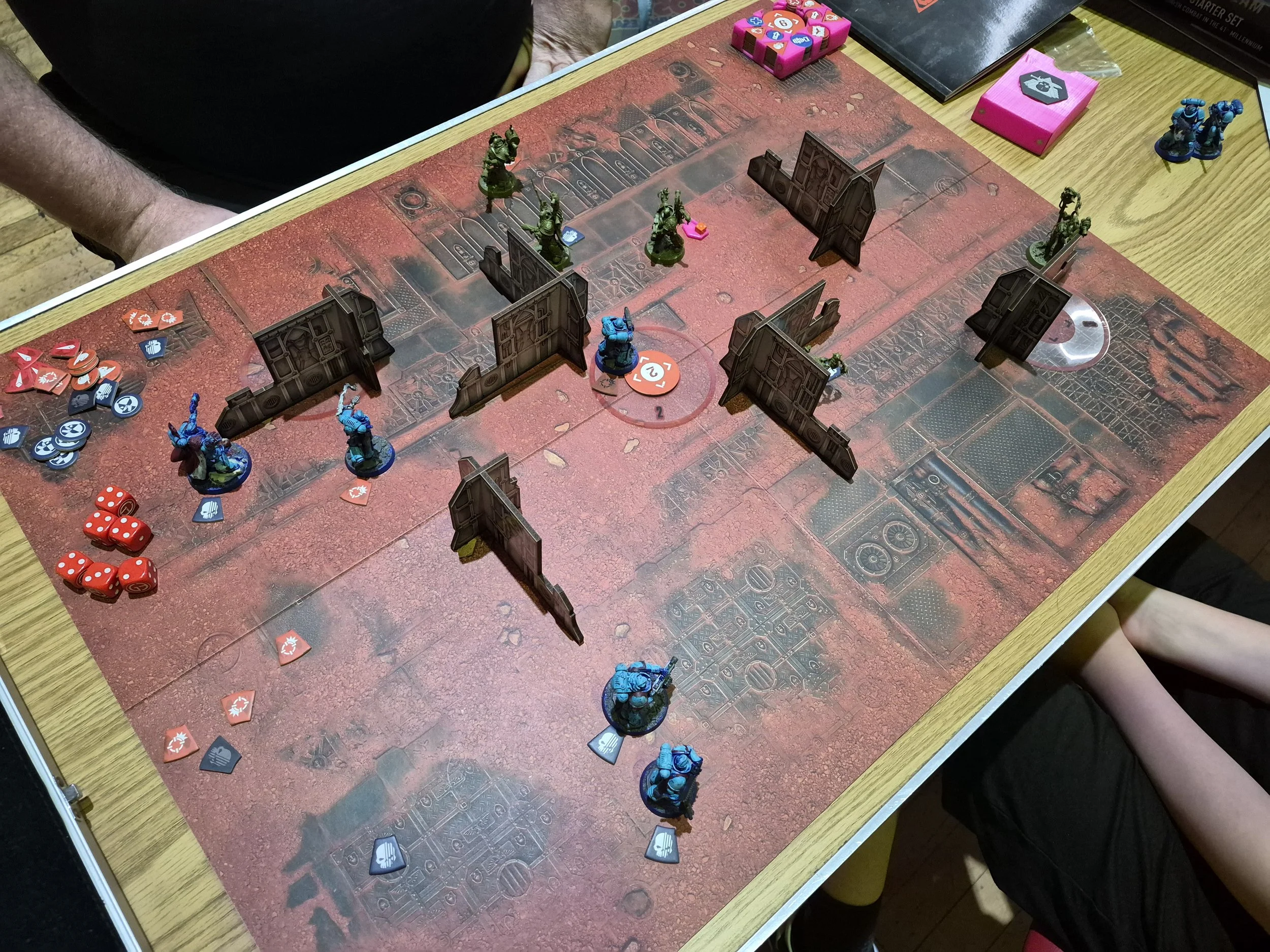 A tabletop board game with miniature soldiers, game cards, and dice, indicating an ongoing strategic game session.