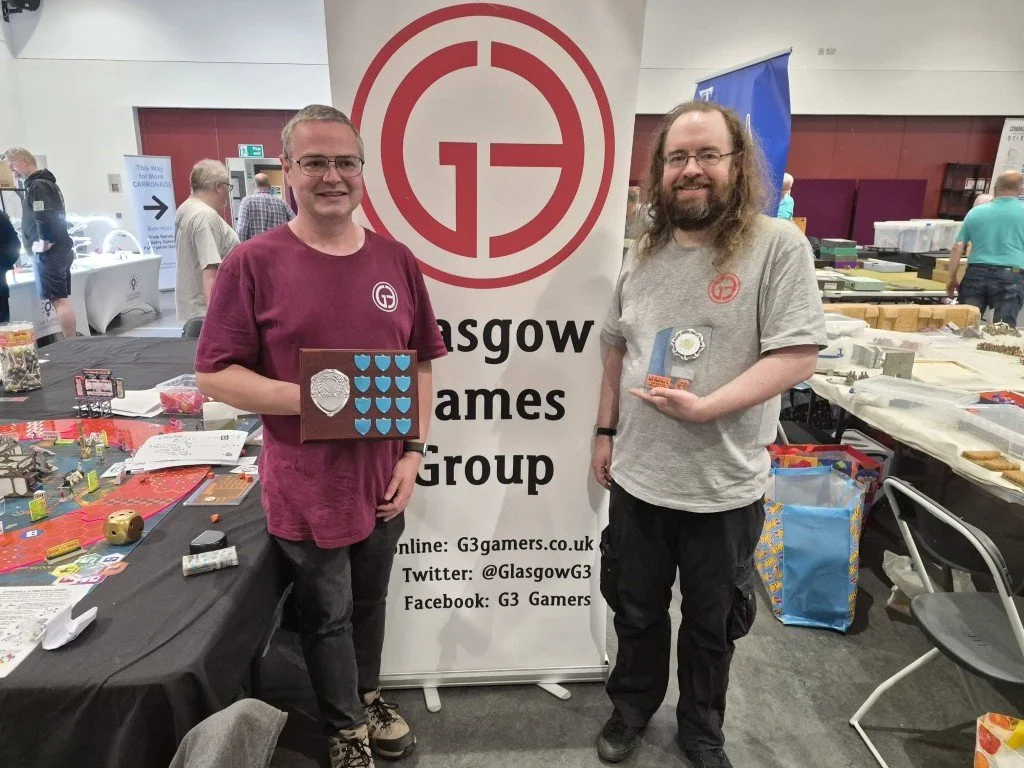 Andrew and Drew showing the trophies for Best Participation Game at the show.