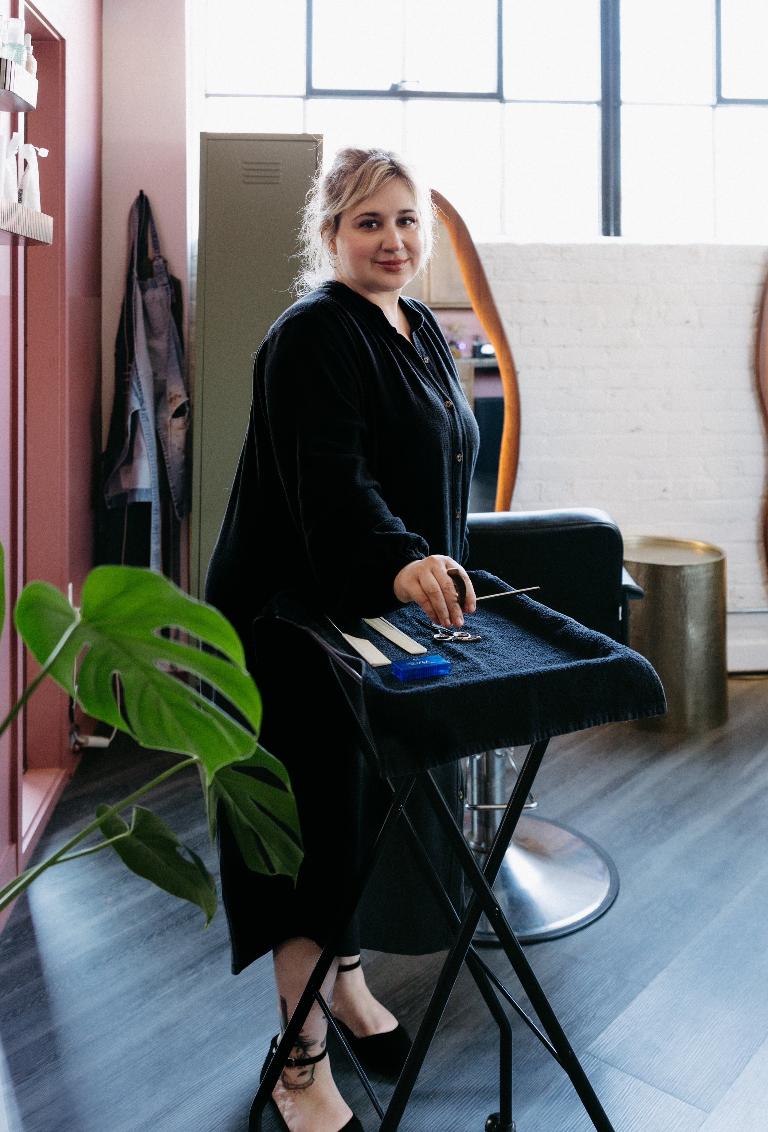 Hair educator JoAnn Bollinger organizing tools for a stylist training session in the Sunday Studio salon.