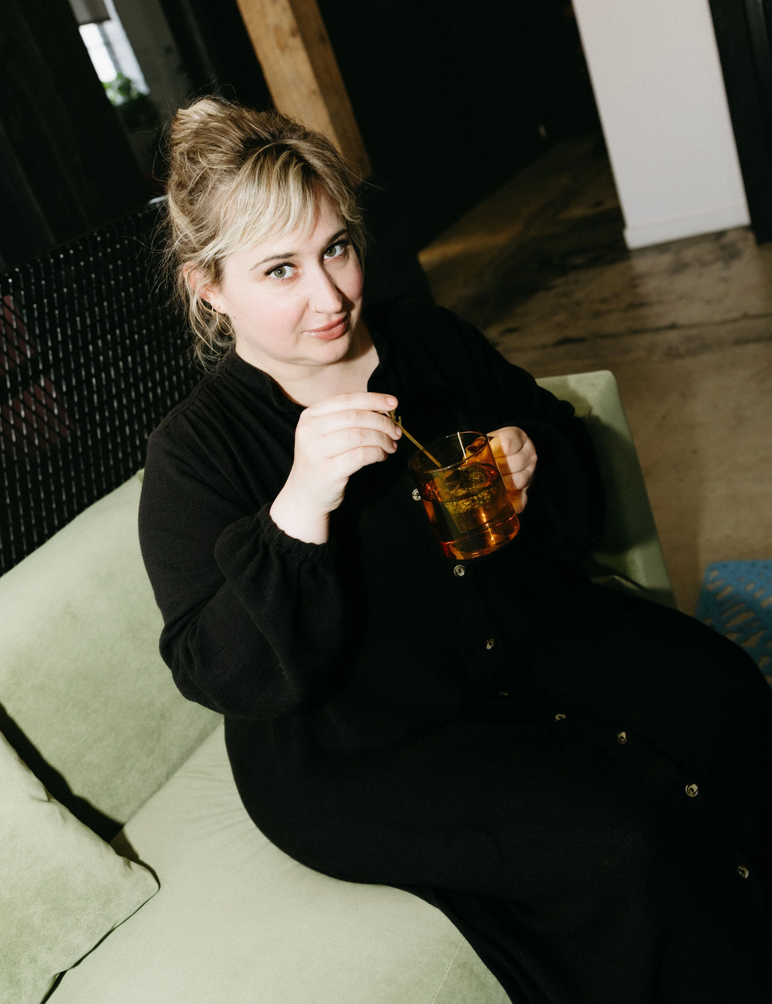 JoAnn, a blonding and razor-cut specialist in Richmond VA, seated with a cup of tea in the salon.