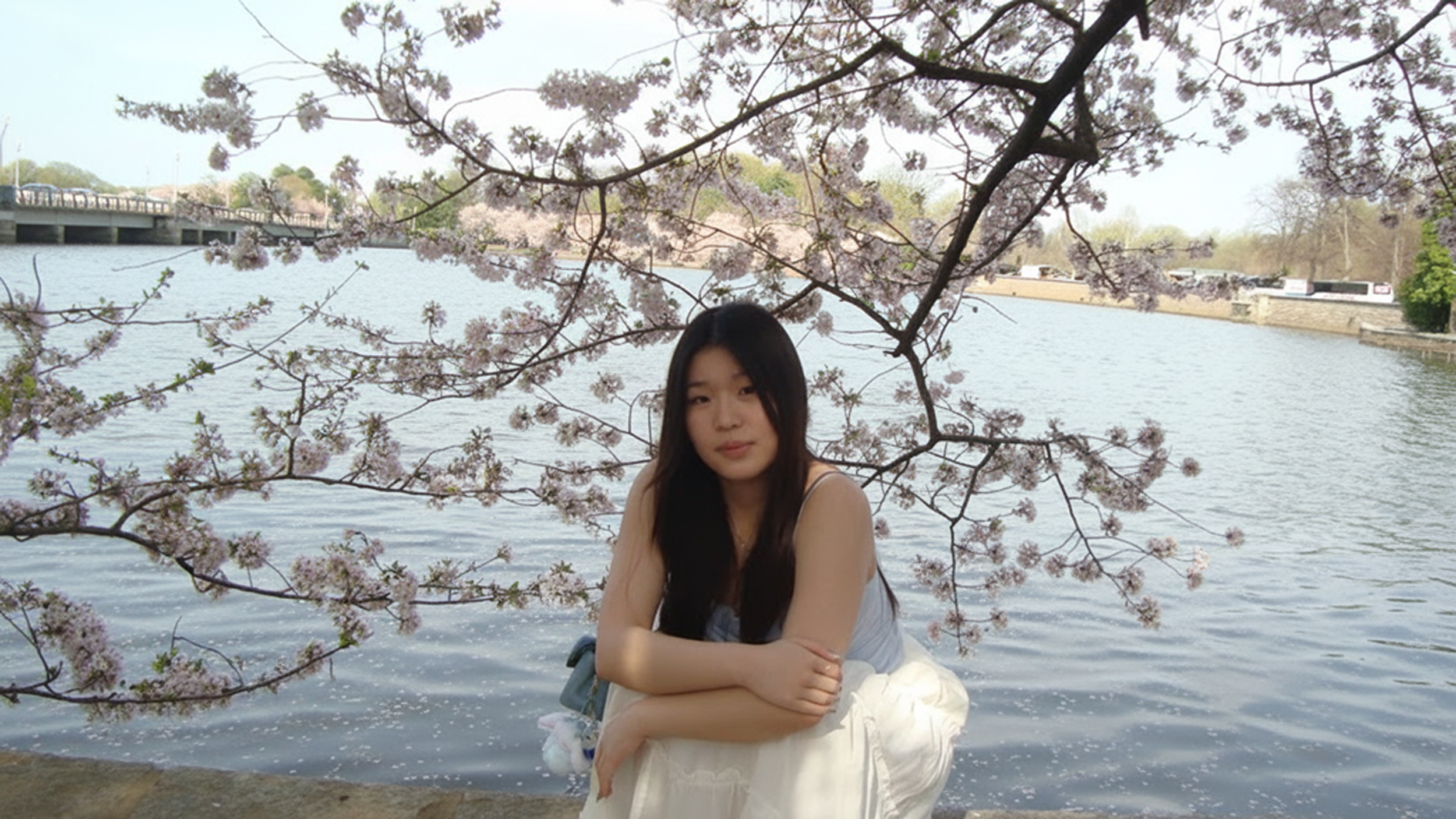 Lina Wu poses with cherry blossoms in DC.