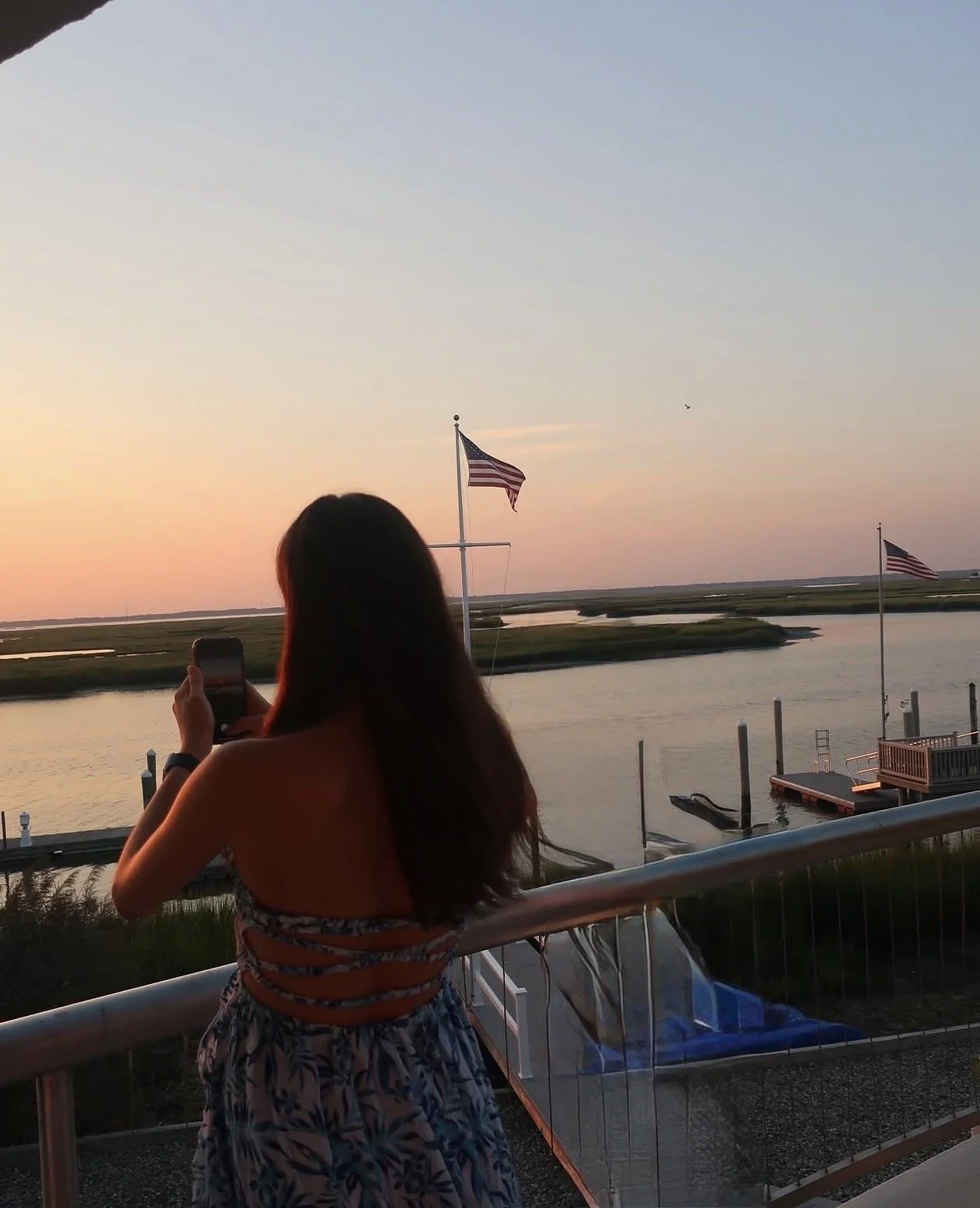 Mia Karalis takes a photo by the harbor.