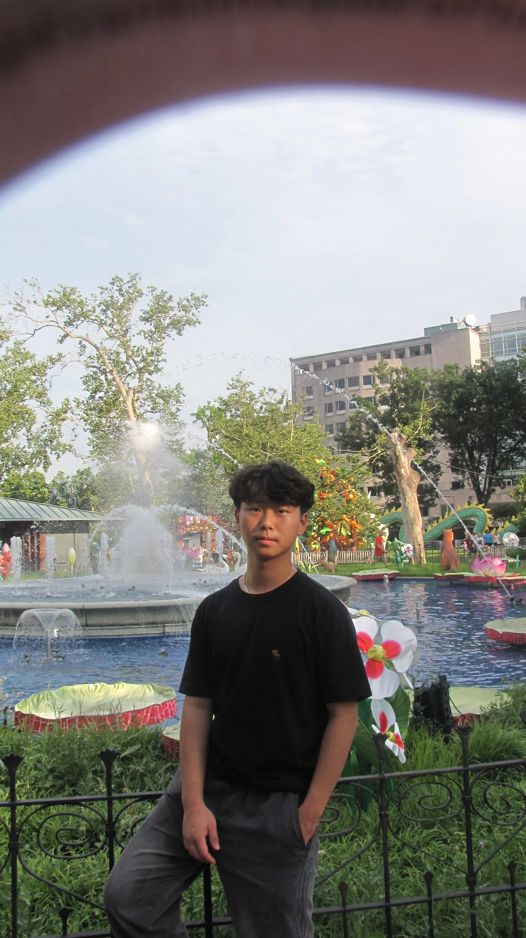 Daniel Li poses in front of water.