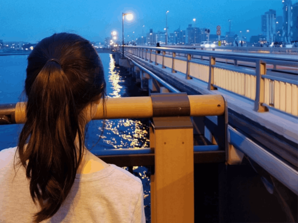 Chelsea Zhu stands at a harbor