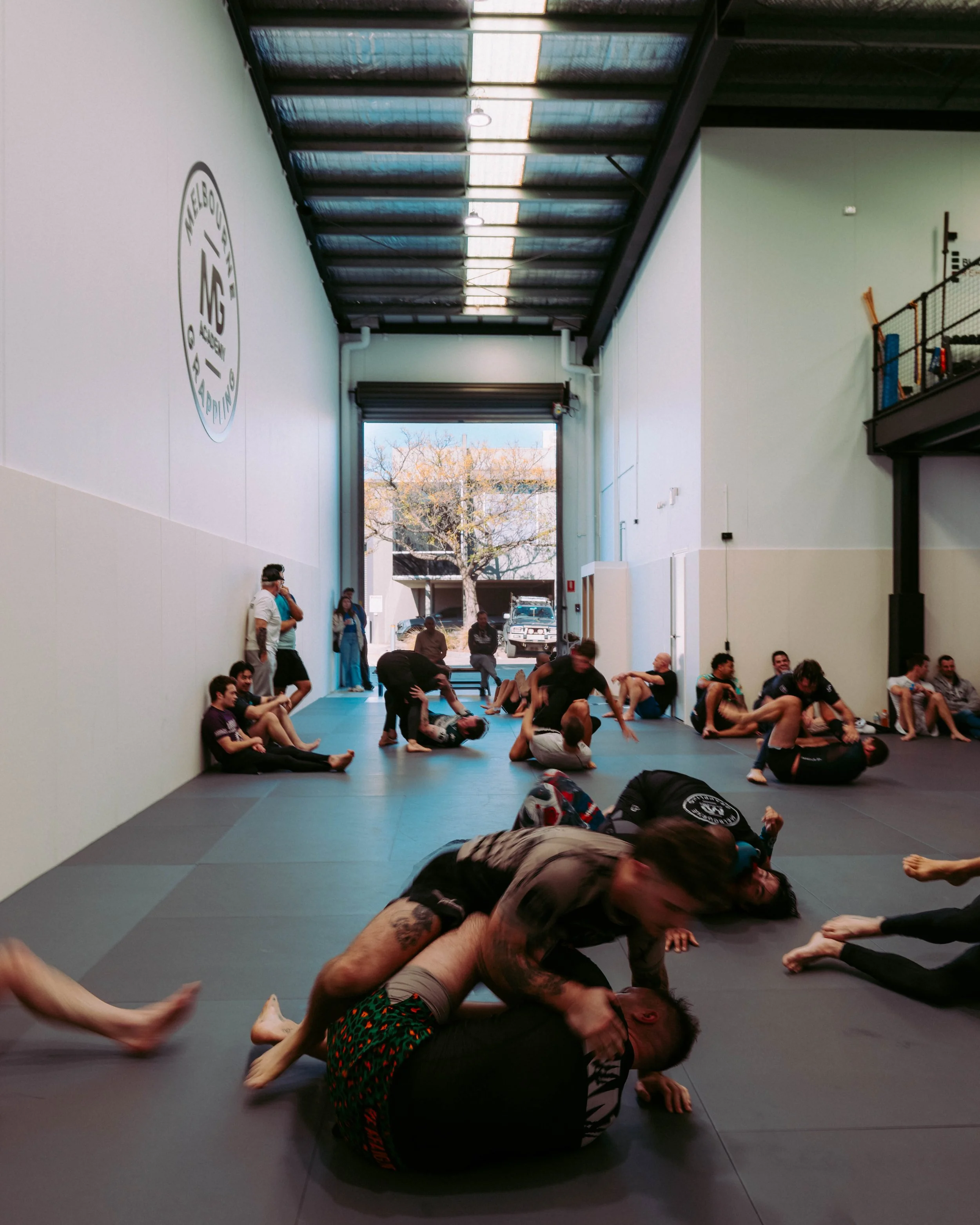 Members sparring during a busy open mat session at Melbourne Grappling Academy