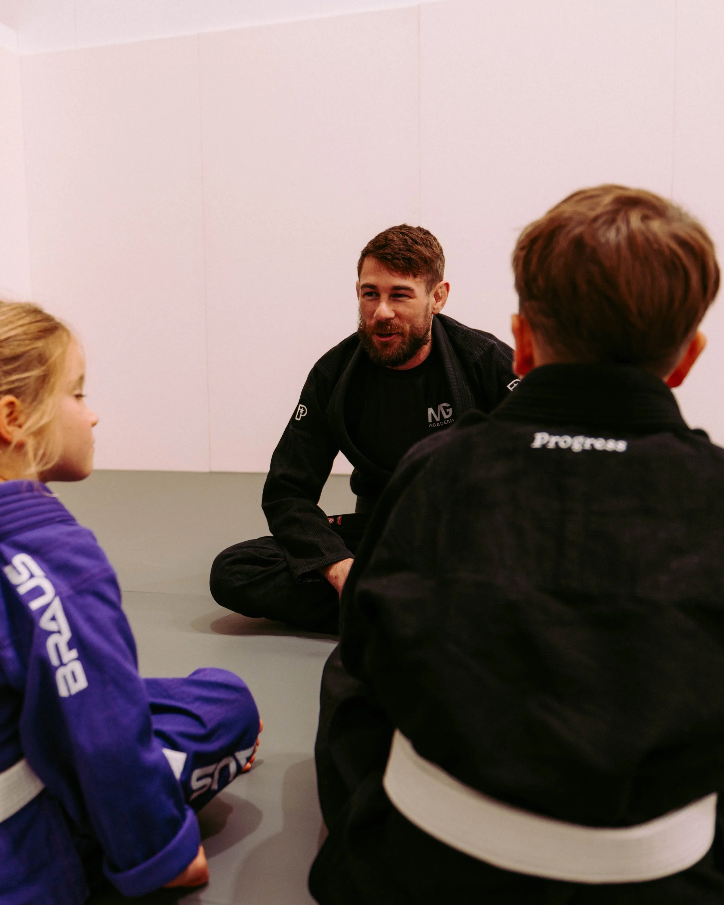 Tom Everett coaching a group of kids during a BJJ class at Melbourne Grappling Academy