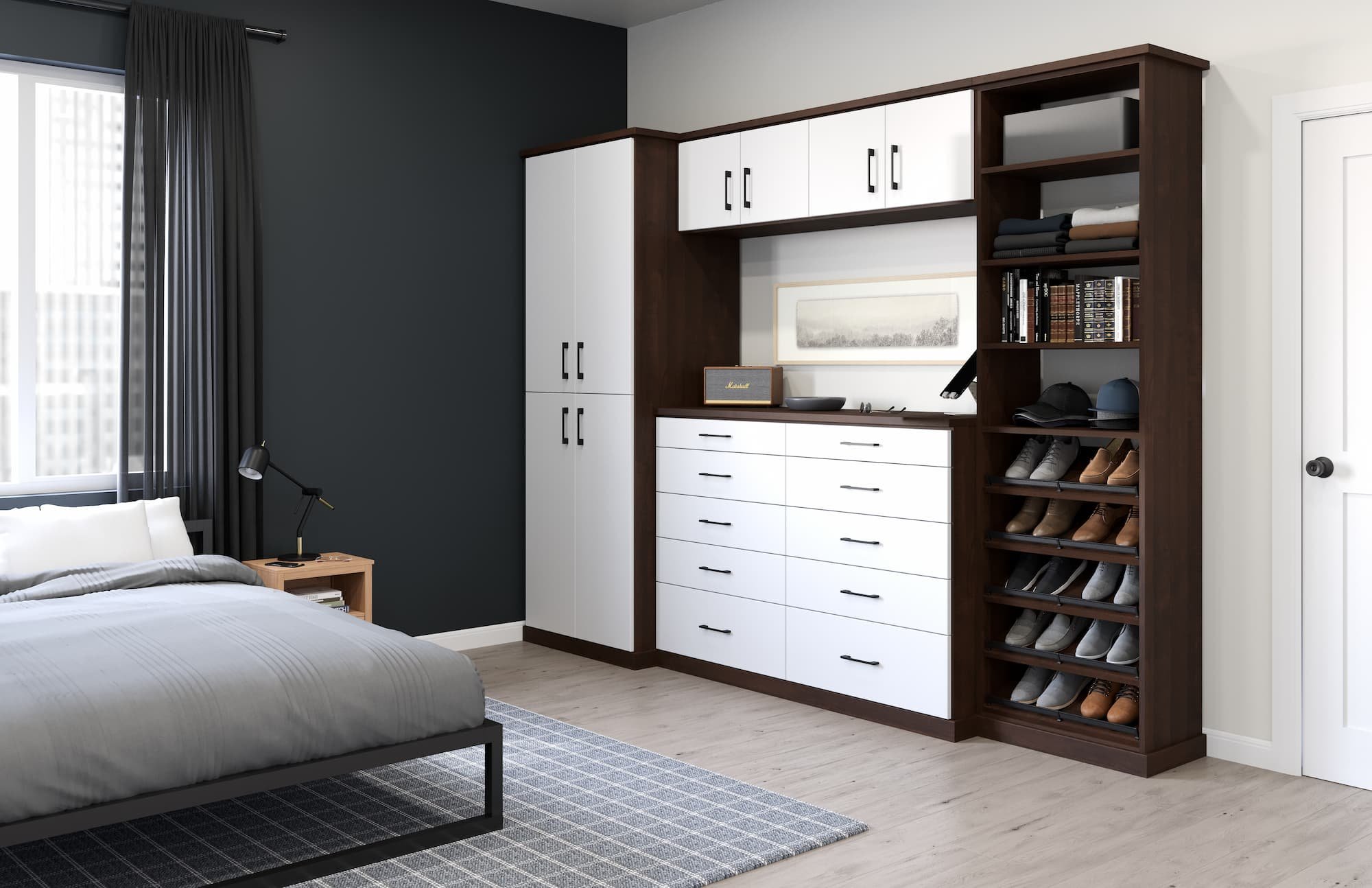 A bedroom with a bed on the left side, a nightstand, and a dark-colored wall. On the right, there is a large wooden and white storage unit with drawers, shelves, and cabinets, with shoes visible in a shoe storage compartment. There is a window with d