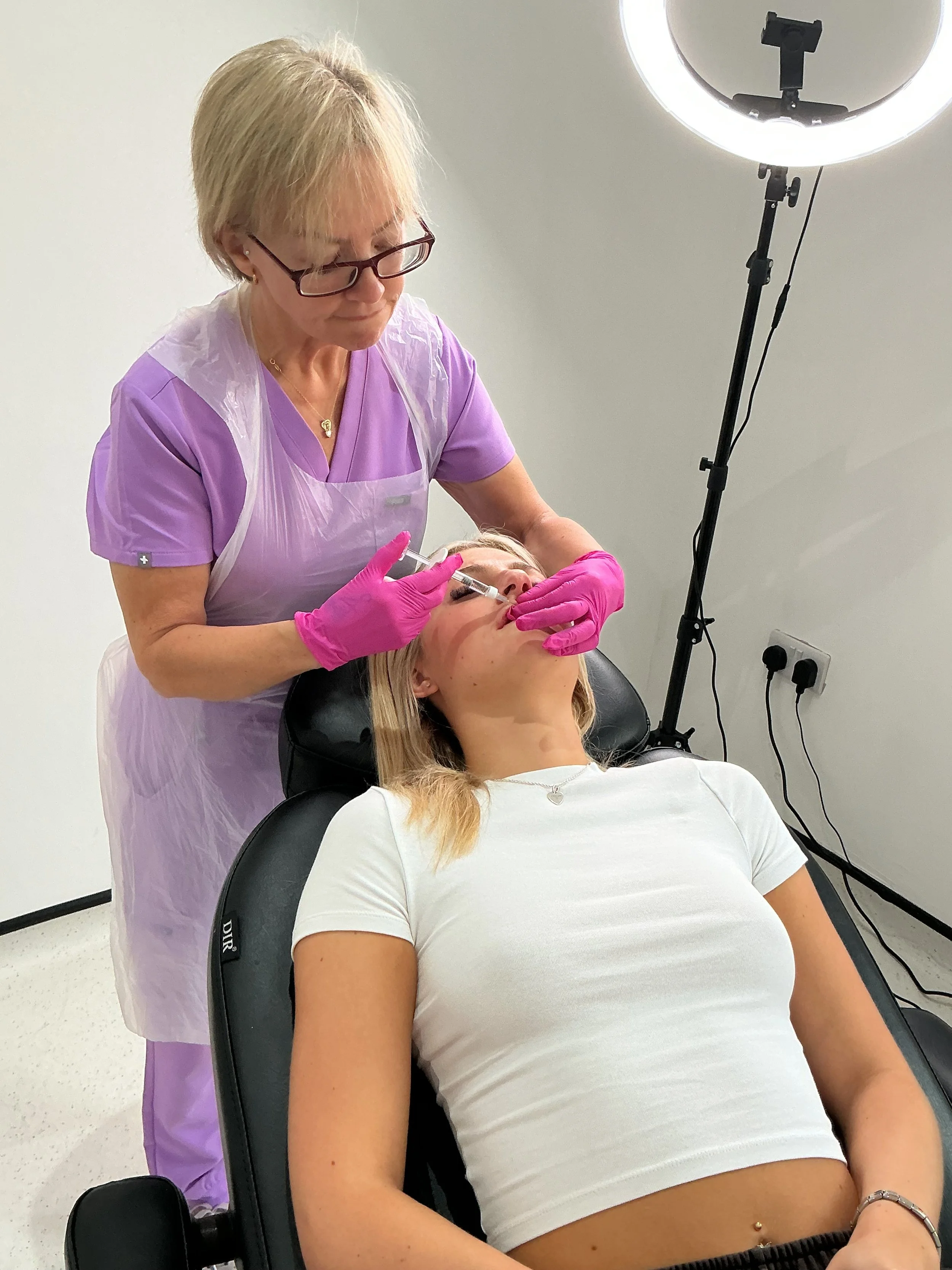 Sandra carrying out a lip enhancement treatment during client appointment 