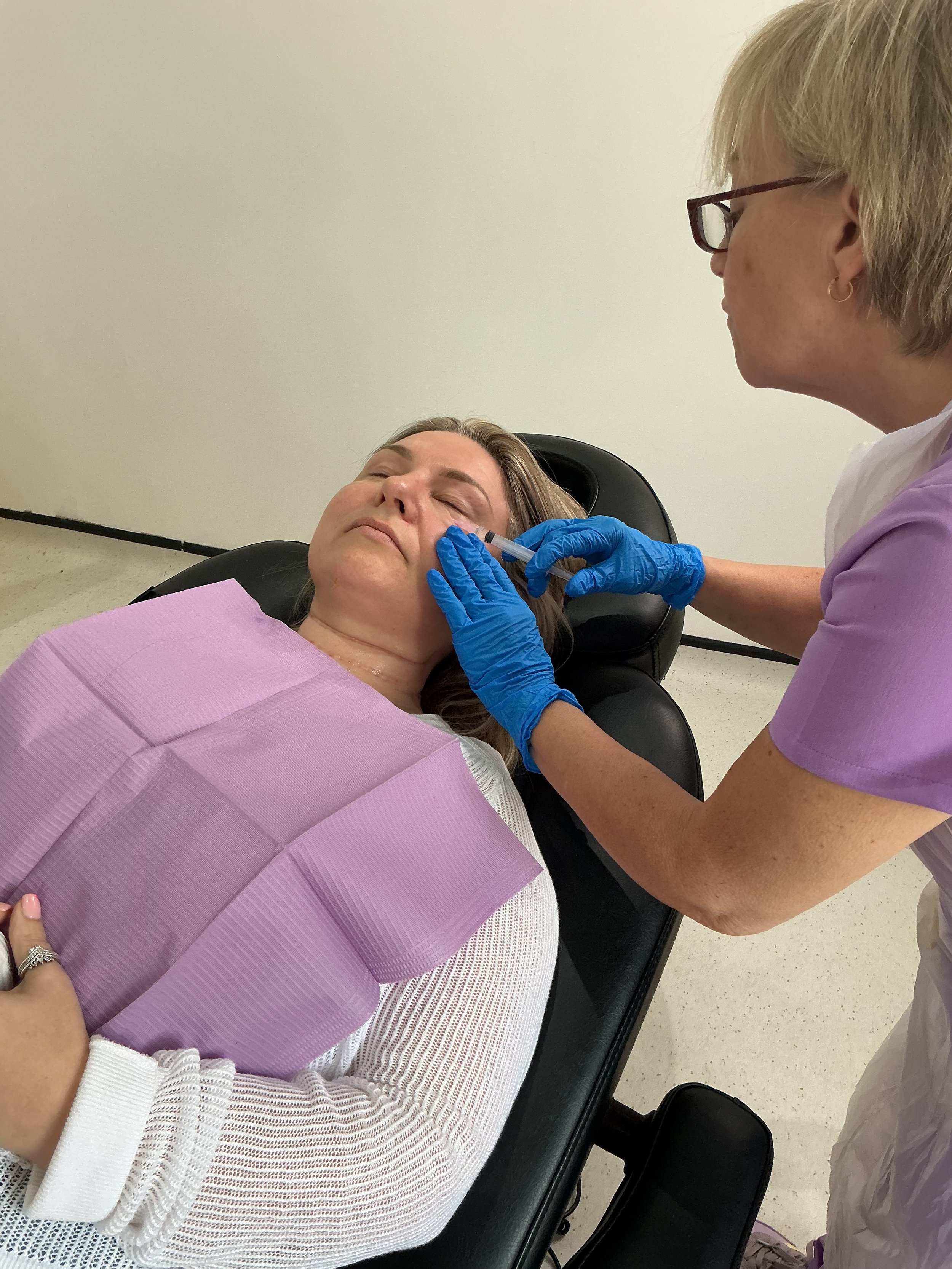 Sandra performing aesthetic treatment during client appointment