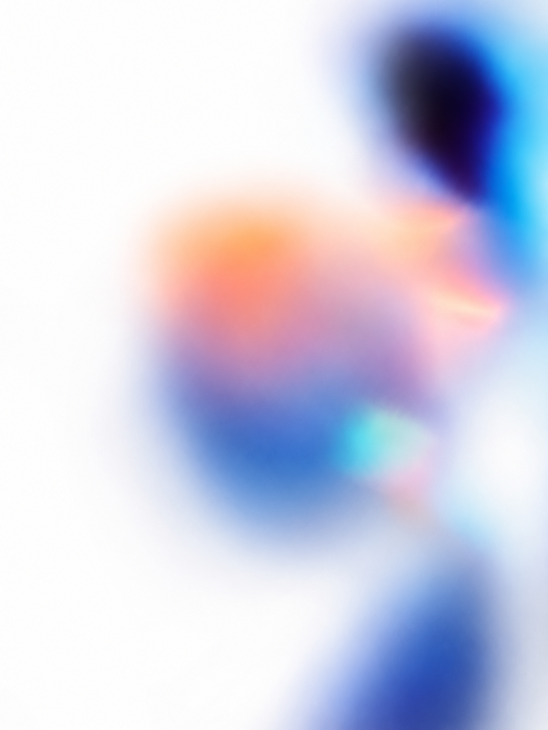 Blurred abstract image with soft gradient of colors including white, blue, pink, and purple.