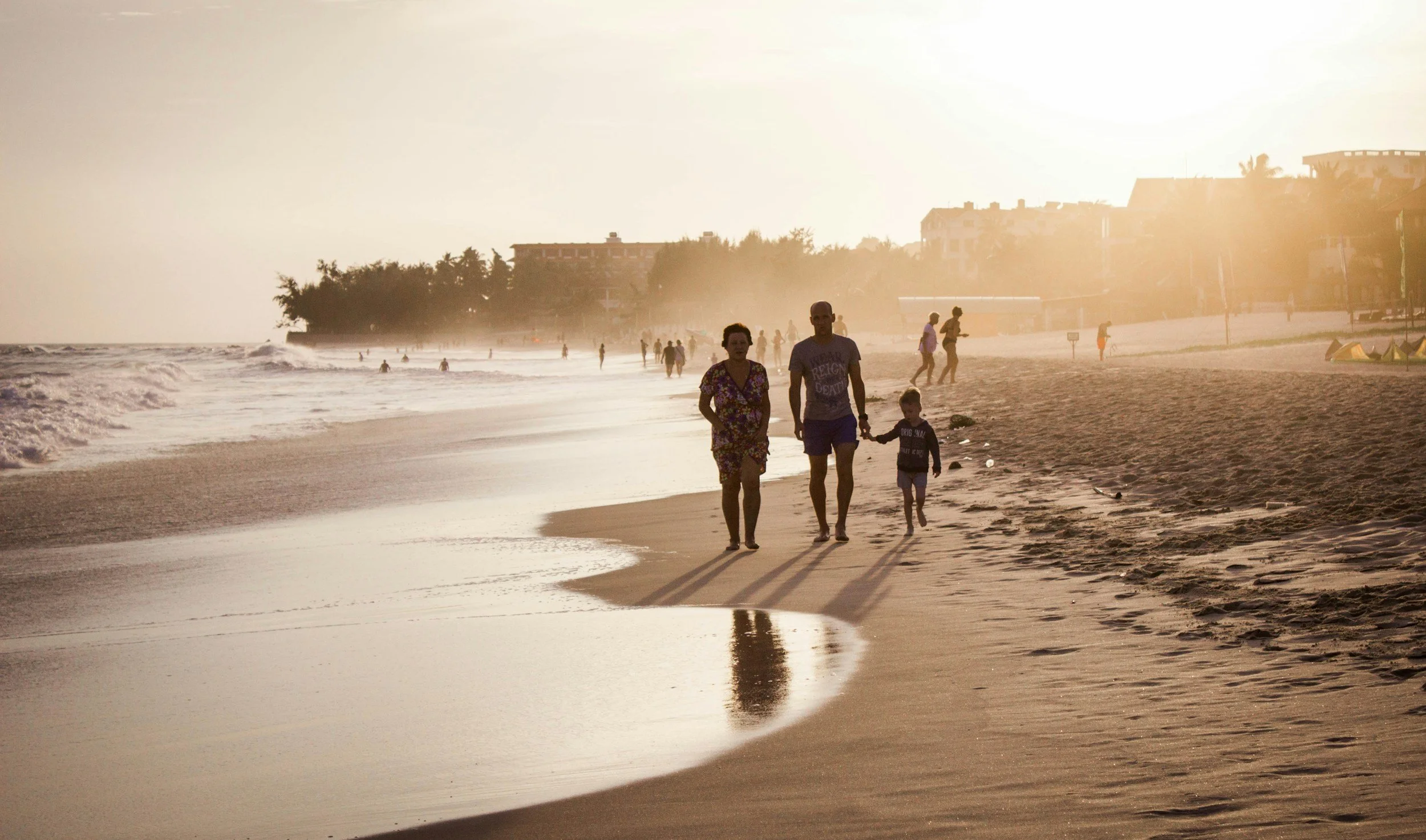 family walking on a beach