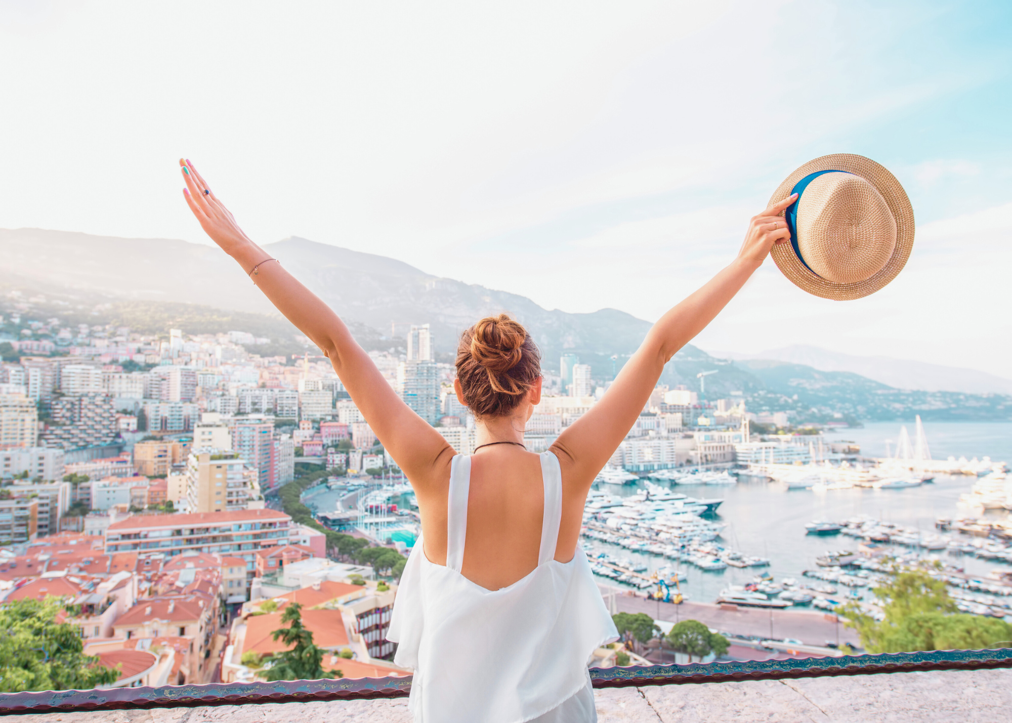 woman with outstretched arms overlooking marina