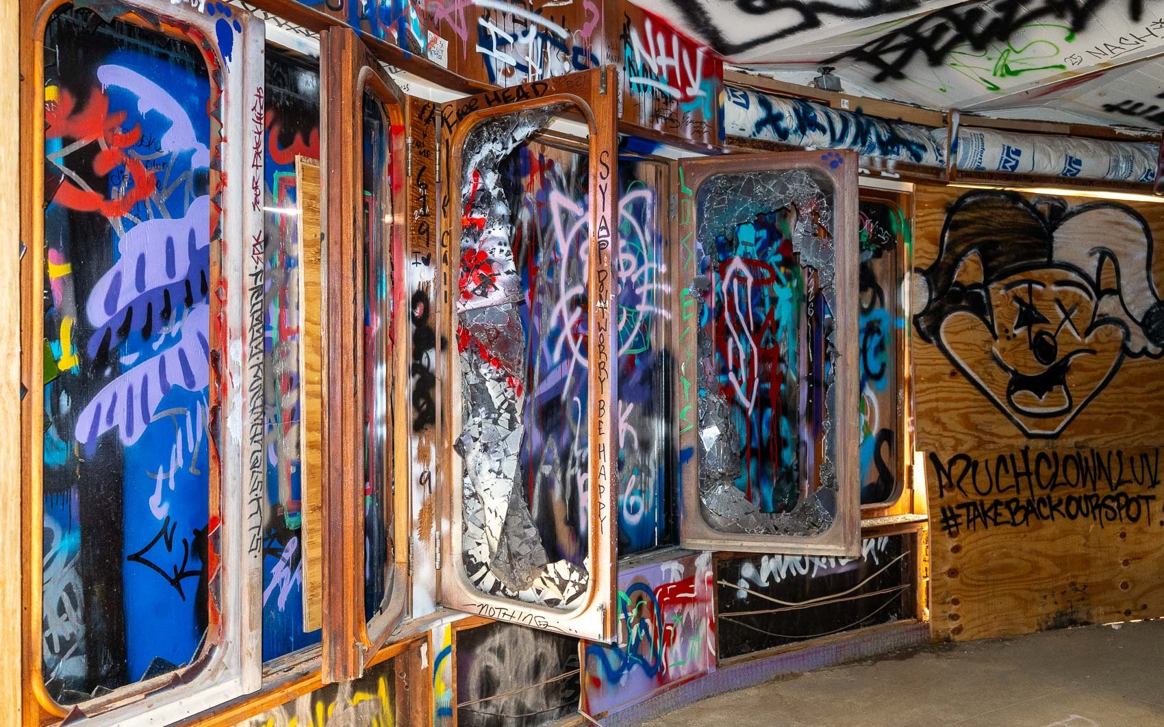   The Mushroom House’s windows have been boarded up due to fall risks. The exterior has been repainted, but the interior remains covered in graffiti.  