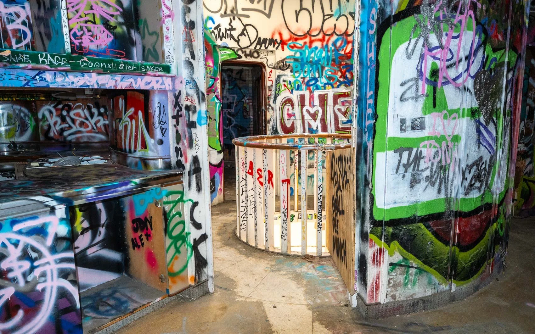   The entrance to the Mushroom House’s living area. The exterior has been repainted, but the interior remains covered in graffiti.  
