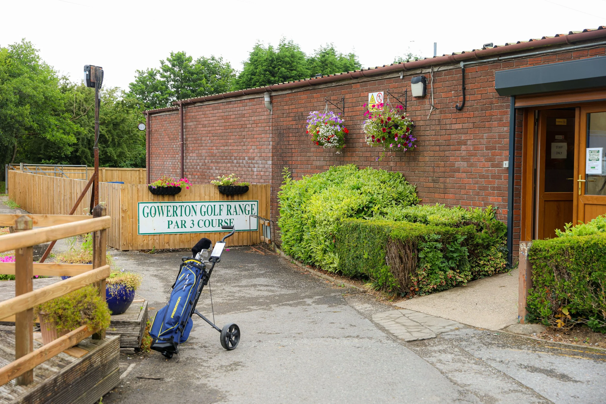 The entrance to Gowerton Golf Range Swansea, with a golf bag in the foreground