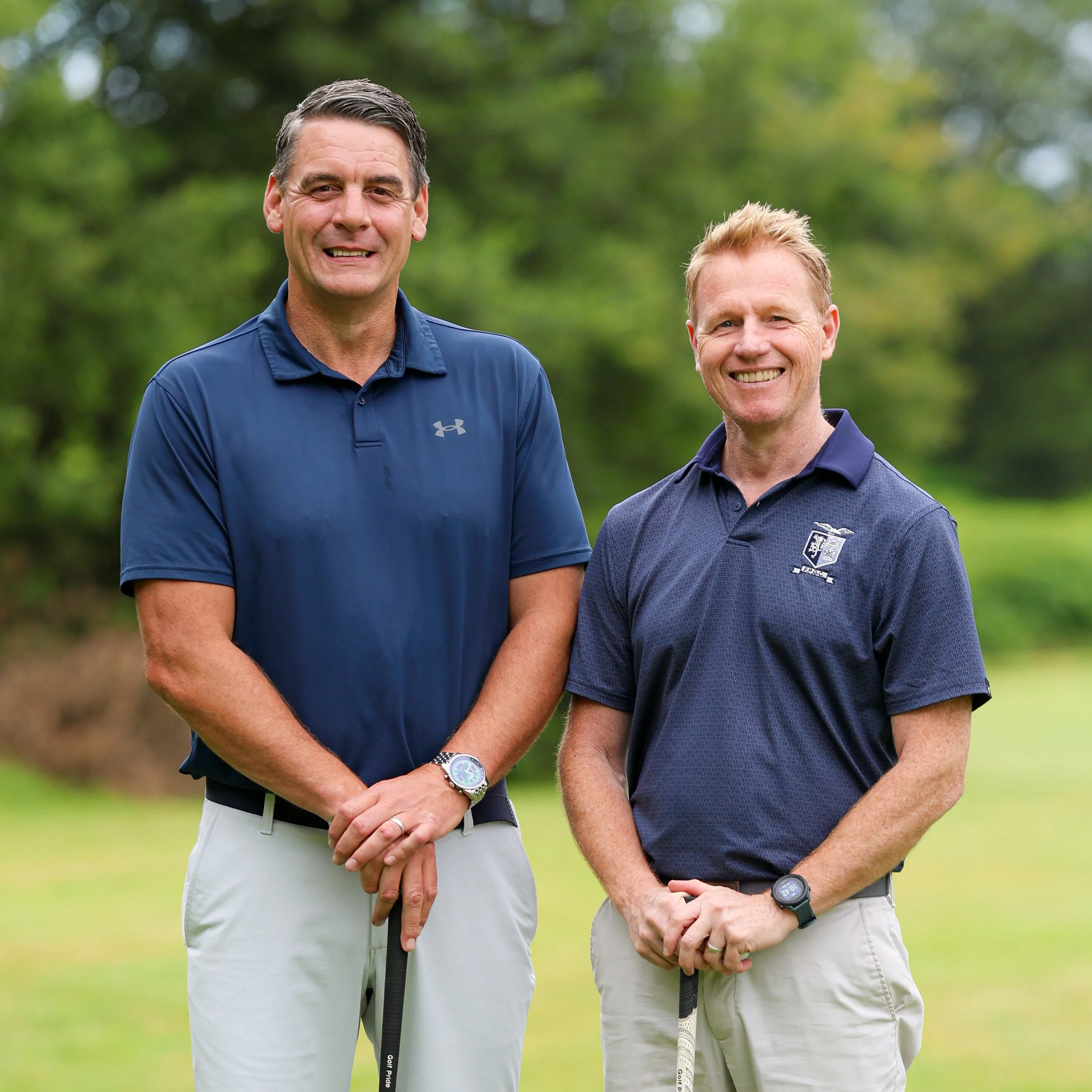Range Directors and part of our on-site Pro Team, Gethin Collins and Mike Hobbs, wearing navy tops with the Par 3 Course in the background.